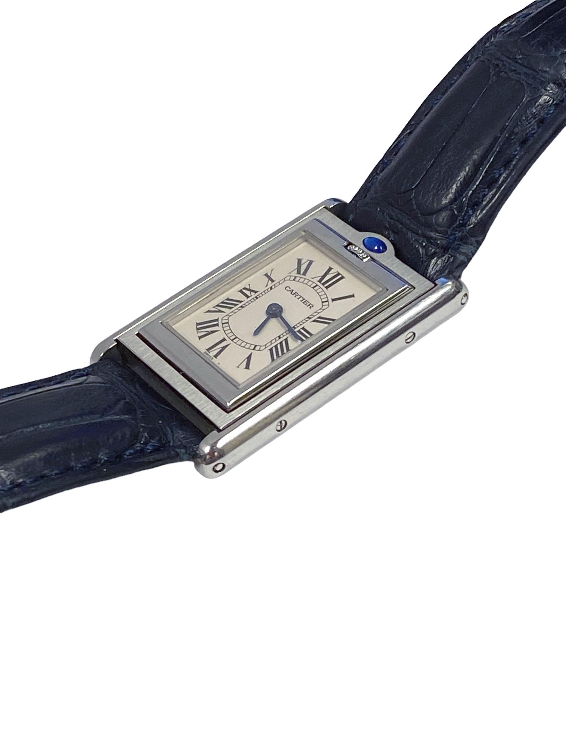 Circa 2000 Cartier Basculante reference 2405 Wrist Watch, 27 X 23.5 M.M. Stainless Steel 3 Piece case. Quartz movement, Silver White dial with Black Roman numerals and a Cabochon Sapphire at the pull to flip the watch. Original Black leather strap