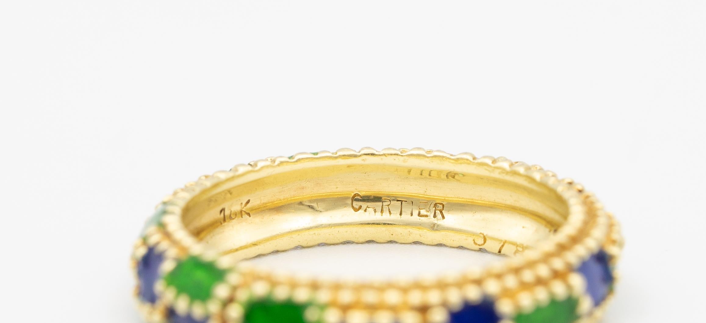 Cartier ring finely crafted in 18K Yellow gold with Blue and Green enamel.
Beaded details. Domed band
Size: 6 1/2
Width: 3/16