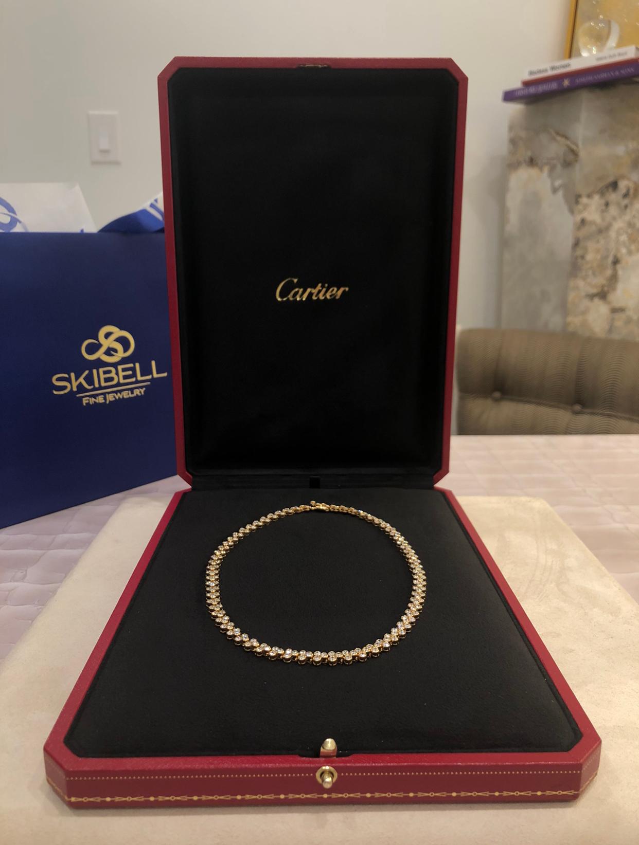 Cartier Bezel Set Diamond Necklace in 18K Yellow Gold. The necklace features 12.60ctw of brilliant round cut diamonds, F-G color, VVS clarity. The necklace is 15.5 inches long and 1/4 inch wide. Signed and numbered with french hallmarks. Comes with