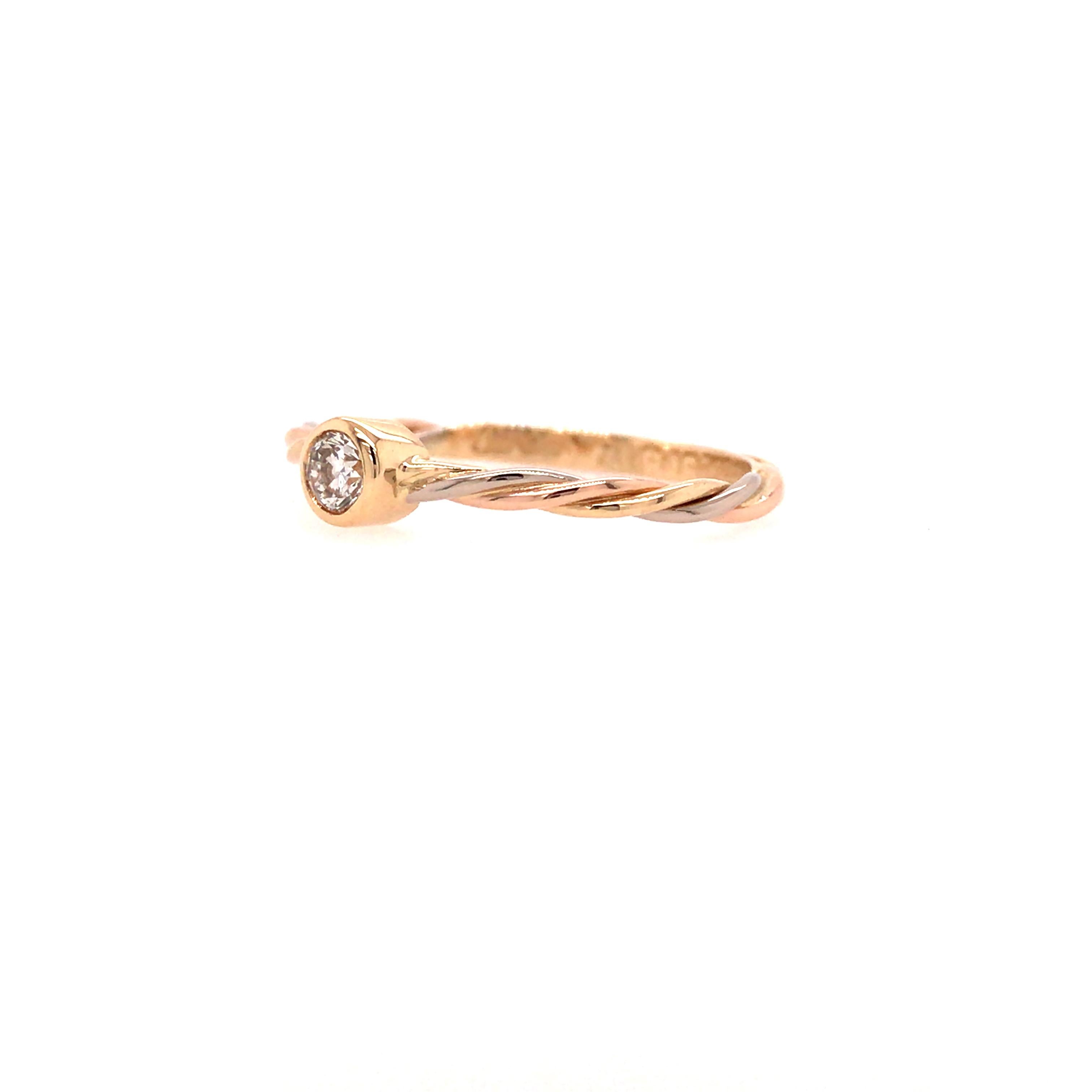 Cartier Bezel Solitaire Rope Ring in 18K Two-Tone Gold.  (1) Round Brilliant Cut Diamond weighing 0.12 carat total weight, F-G in color and VS in clarity is expertly bezel set.  Ring size 5.5.  1.39 grams. Inscribed 