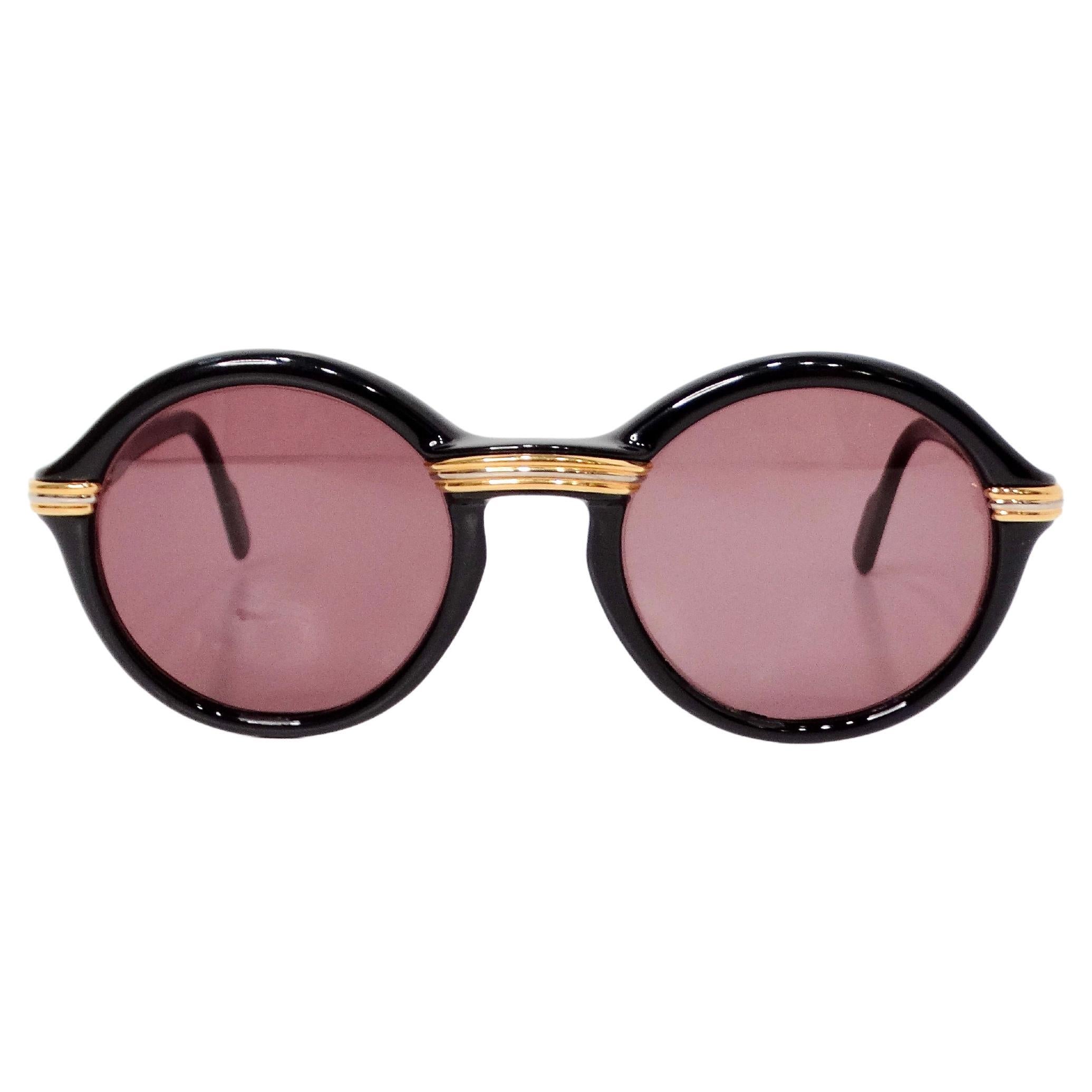 The 1991 Cartier Black Cabriolet Round Sunglasses exude timeless elegance and sophisticated style. Featuring a classic round frame design, these sunglasses are crafted with black acetate that offers a sleek and versatile look, perfect for both