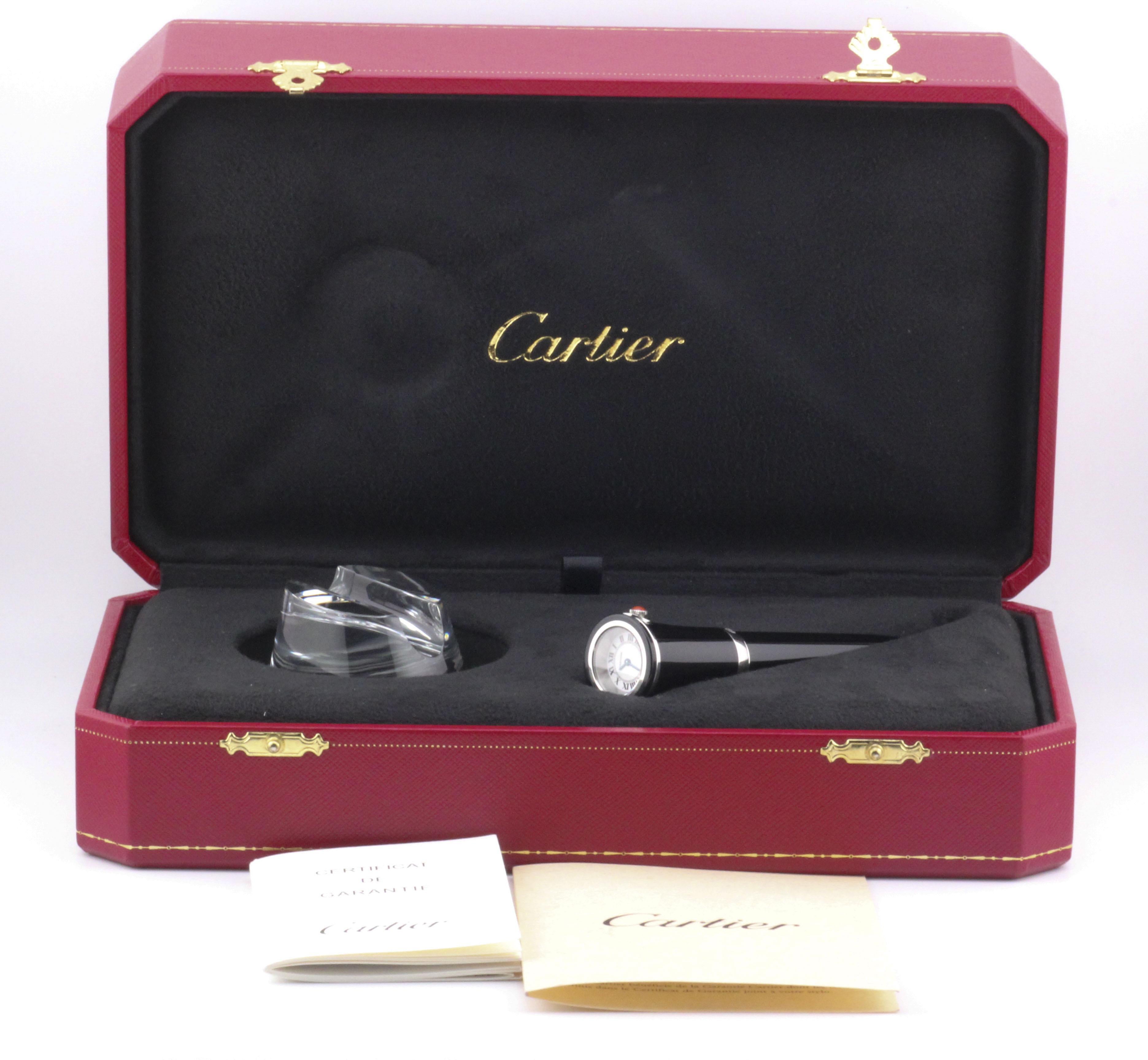 The Cartier Black Lacquer Ballpoint Pen Watch with Crystal Stand, Limited Edition, is a unique fusion of elegance, functionality, and Cartier’s iconic luxury. This collector’s piece combines the refinement of a fine writing instrument with the