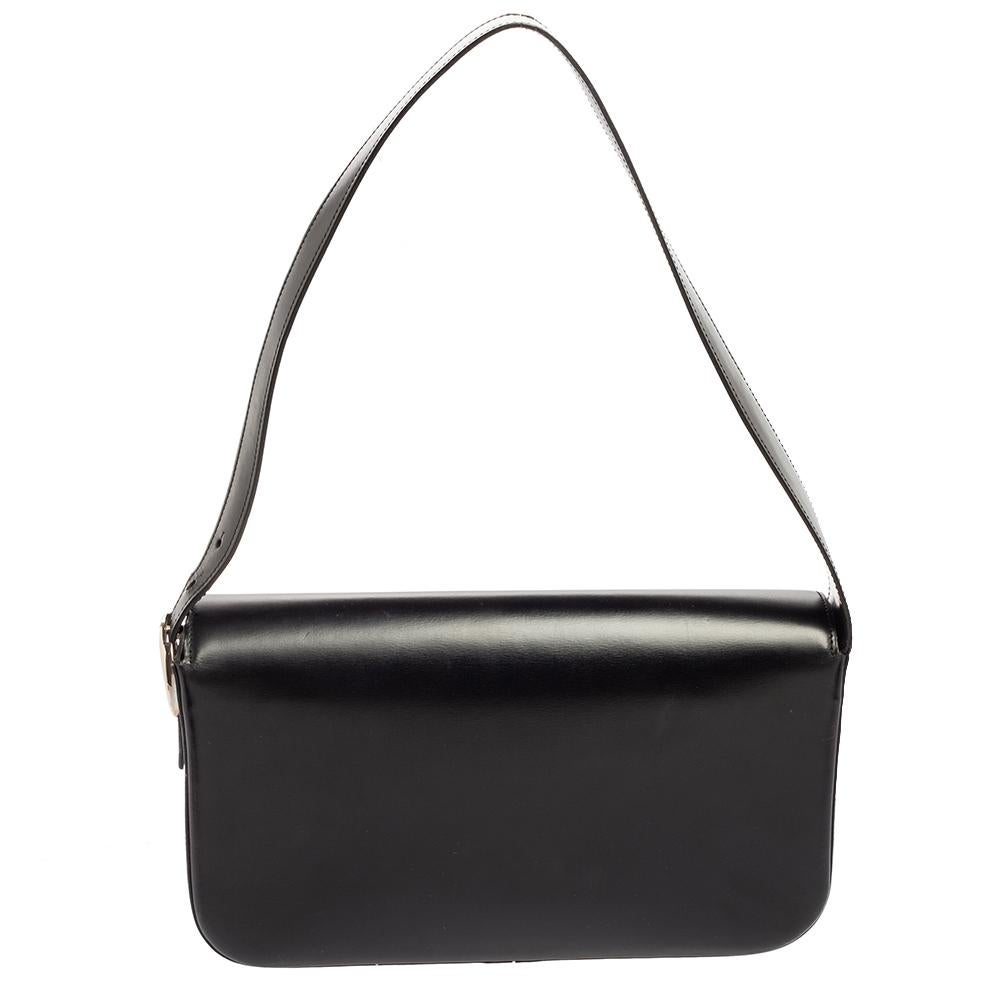 The shoulder bag is an iconic creation from the House of Cartier. It is made from black leather into a sleek silhouette. It features a suede-lined interior, silver-toned hardware, and a handle drop. Swing this Cartier bag in style!

Includes: Info