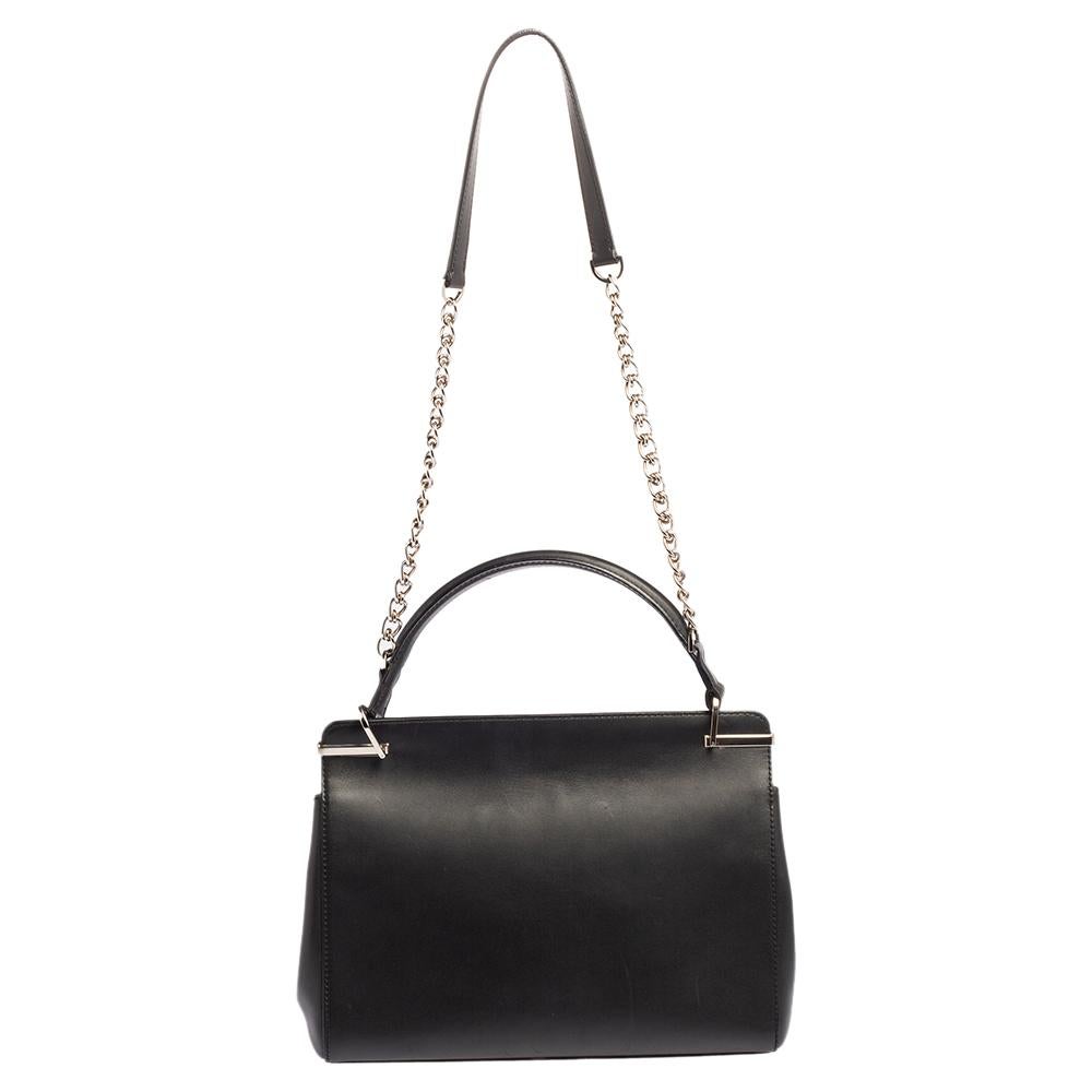 With a well-designed body and elegant appeal, this bag from Cartier is lovely both as a work and evening bag. It is crafted from leather and features a front flap with gold-tone hardware details. The bag boasts a suede-lined interior housing a slip