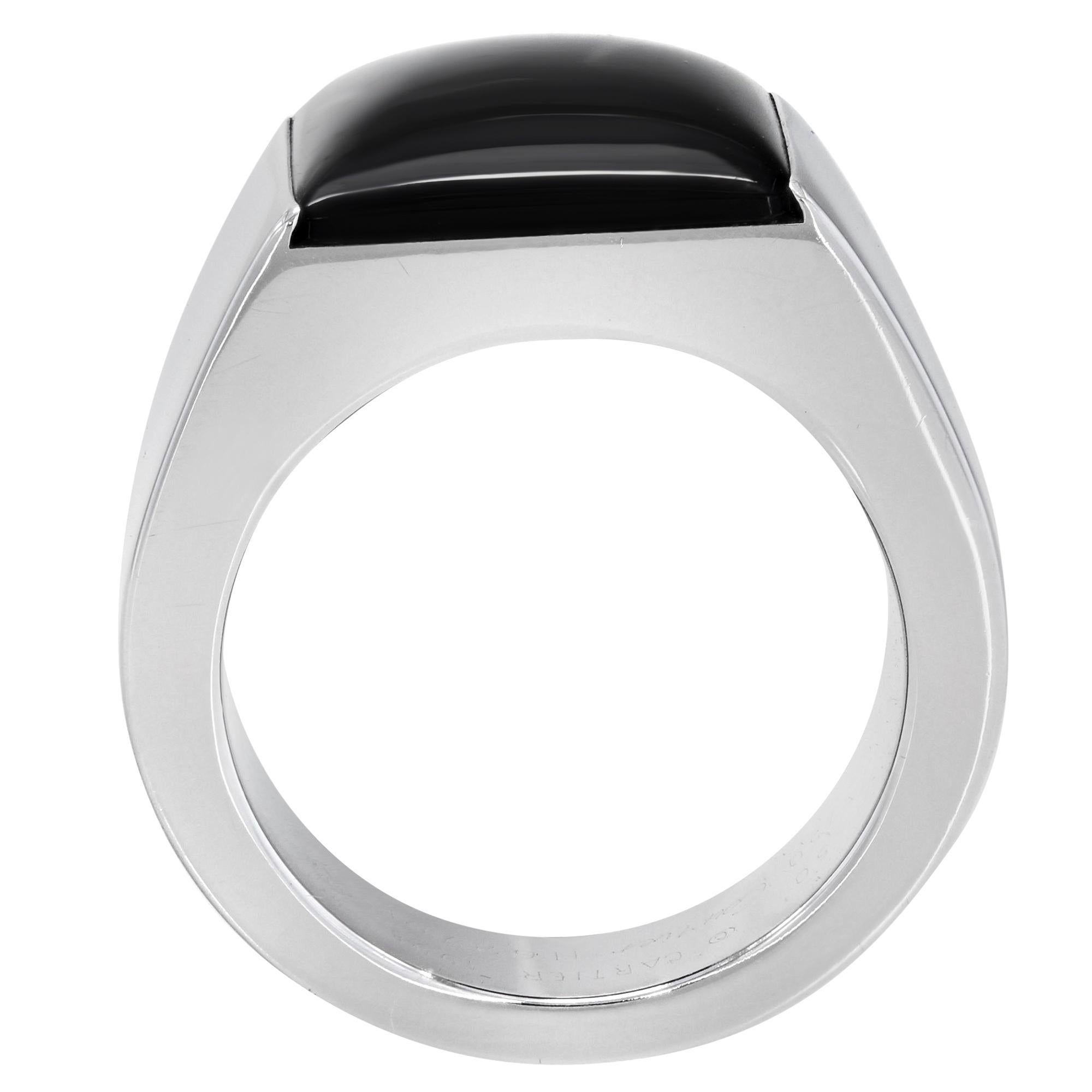 Cartier 18K White Gold Black Onyx tank ring. Ring was created in 1998. Beautiful pre-owned condition, or 100% of your money back.  This lovely ring is made of 18 karat white gold. The simple band has a single black onyx that gives a look of pure