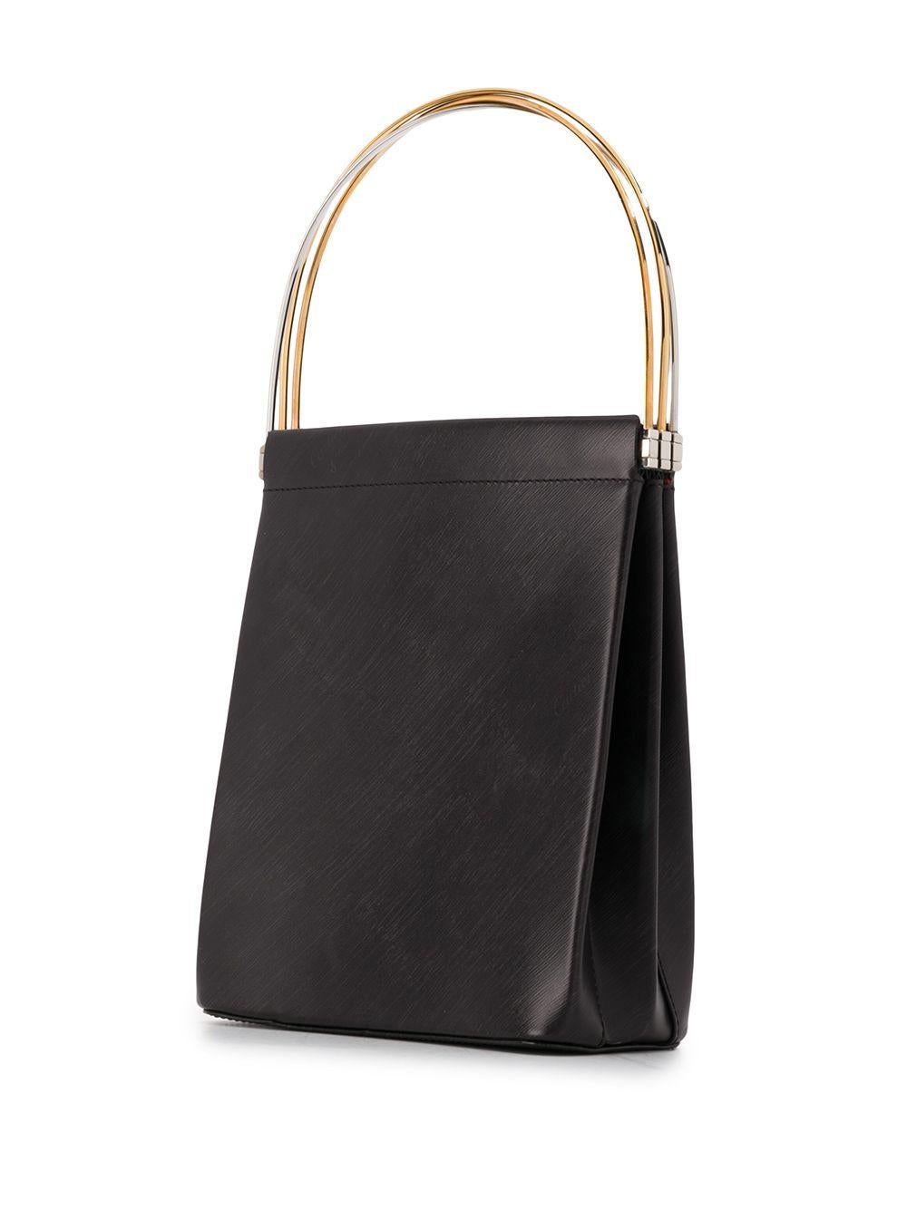 Crafted in France from pure black leather, this classic Trinity cage bag is a true work of art by Cartier, featuring a slim silhouette, a discrete logo screen running diagonally throughout and three iconic round metal top handles in an assortment of
