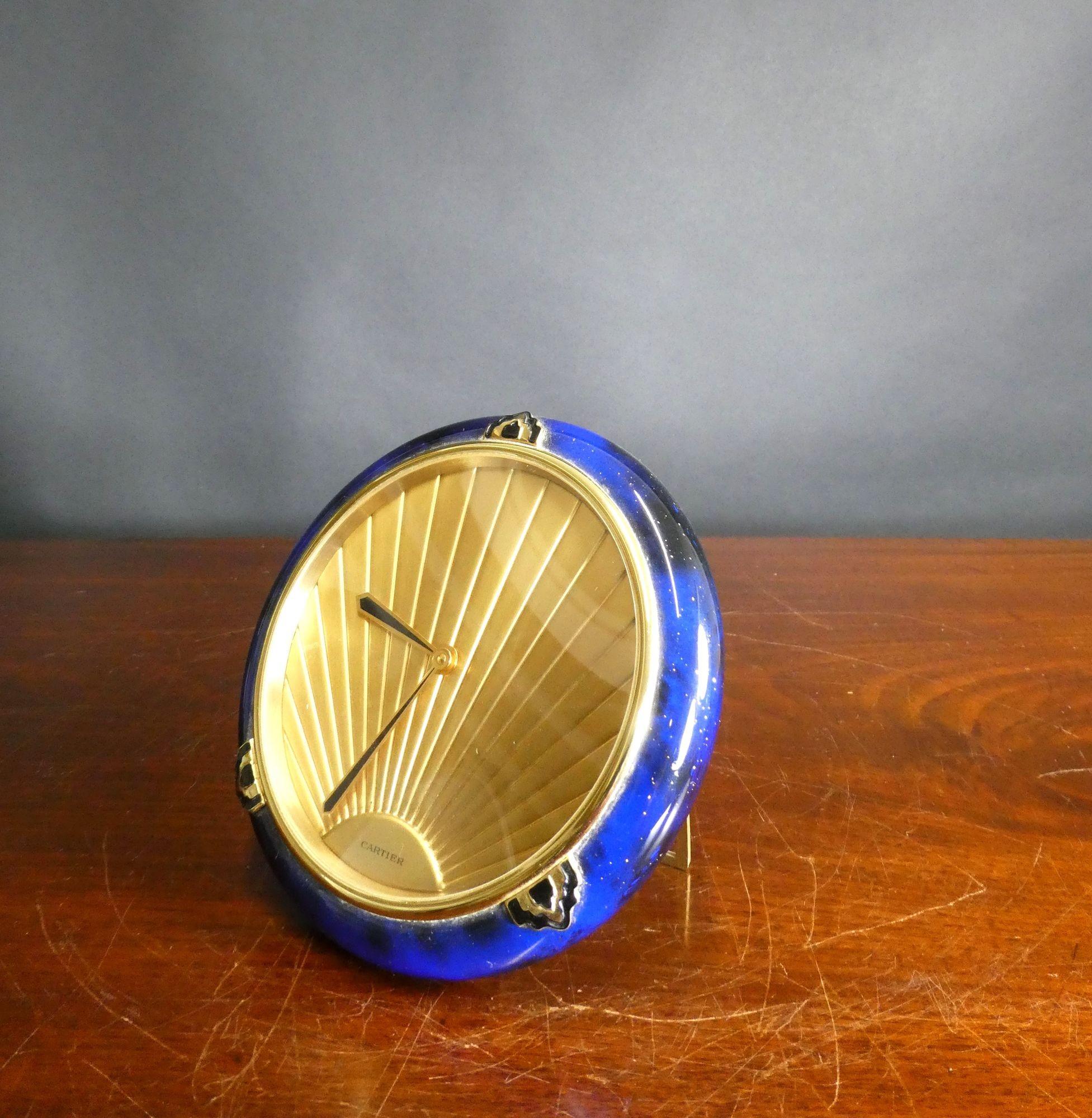 Cartier Blue Enamel Art Deco Style Desk Clock
Cartier Art Deco style desk clock housed in a blue enamel decorated case with brass strut support.
Gilded decorated dial with original black and brass Art Deco style hands signed Cartier.
Quartz movement
