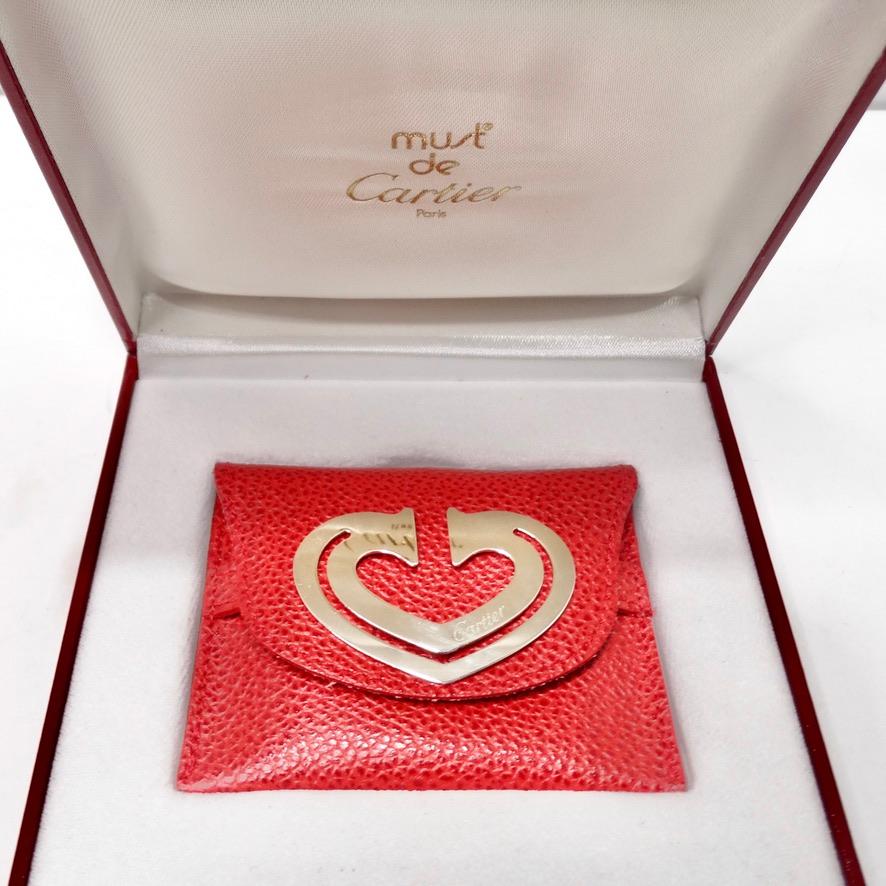 This amazing Cartier bookmark/paper clip circa 1990s is going to be your next favorite desk accessory! Beautiful silver plated heart motif book mark signed Cartier and red leather case. Comes with original Cartier box. This is such a beautiful way