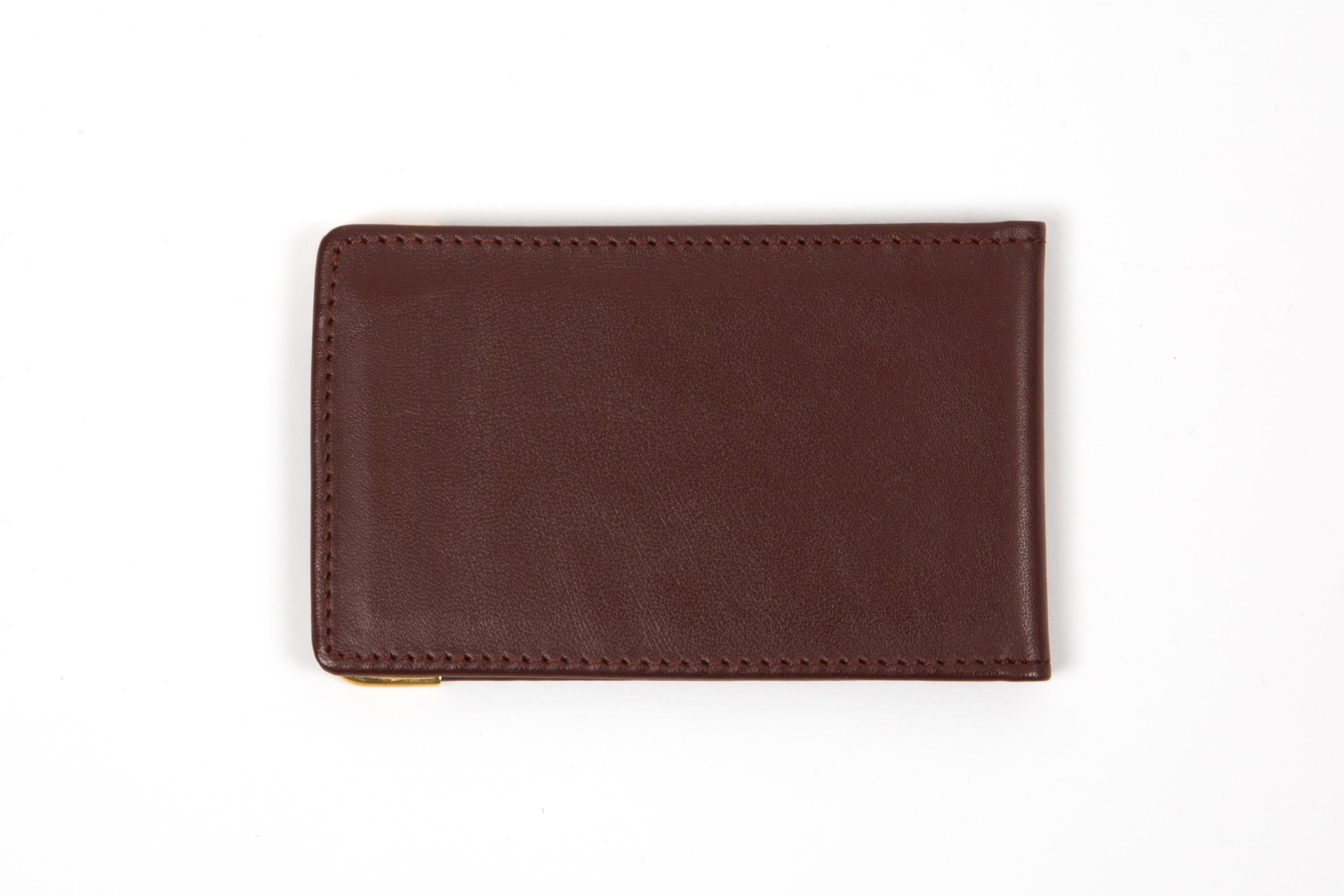 Cartier Bordeaux leather pocket mirror featuring a rectangular shape, a mirror inside, gold-plated corners, and a golden hot-stamped Cartier signature.  
Circa: 1990s
In good vintage condition. Made in France.
3.7in (9.5cm) X 32.3in. (6cm) X 0.39in