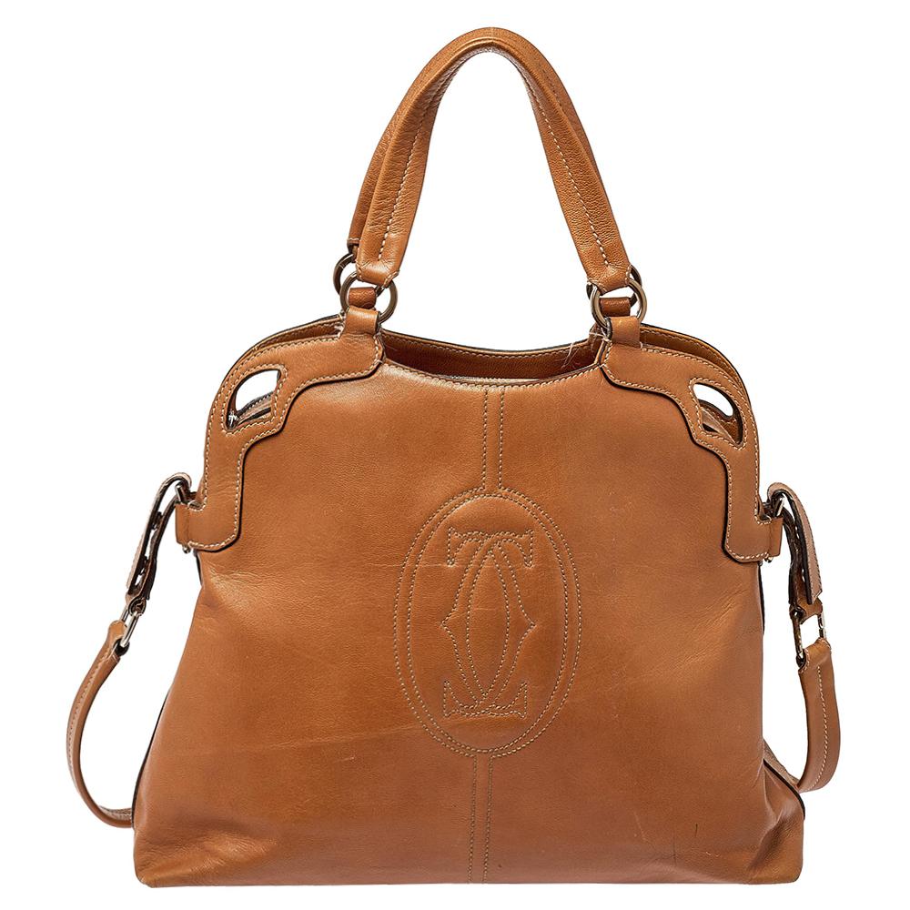This classic Marcello de Cartier handbag will add a glamorous finish to any look. Crafted from luxurious brown leather, the exterior features a large stitched Cartier logo and comfortable double handles. Its large hold all interior is lined with