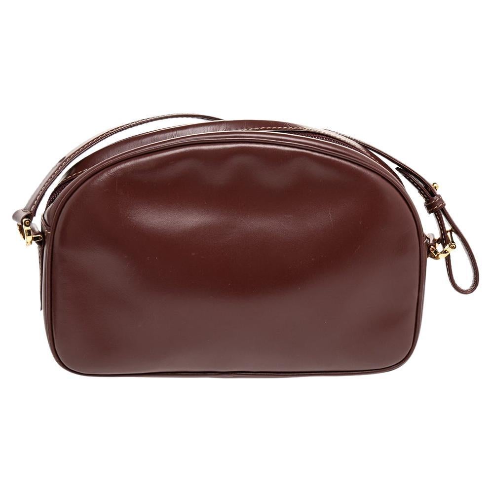 Cartier brings us this well-shaped Must De Cartier bag that has been crafted from leather and flaunts a front flap pocket. The zip-enclosed, fabric-lined interior is for your belongings and the bag is complete with a long shoulder strap.

Includes: