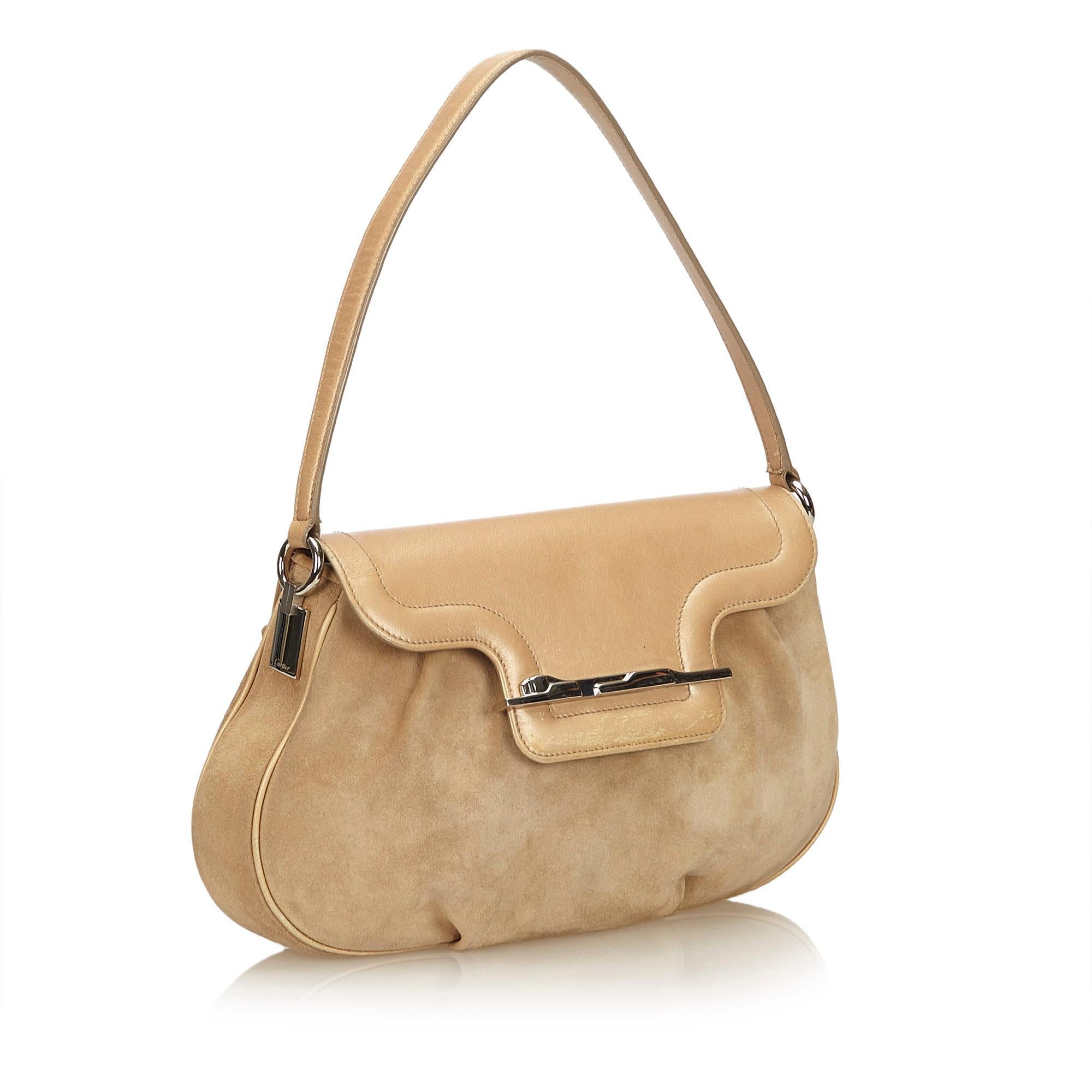 This handbag features a suede body with leather trim, flat leather handle, top flap with magnetic closure, and interior zip and slip pockets. It carries as B condition rating.

Inclusions: 
Dust Bag
Authenticity Card

Dimensions:
Length: 20.00