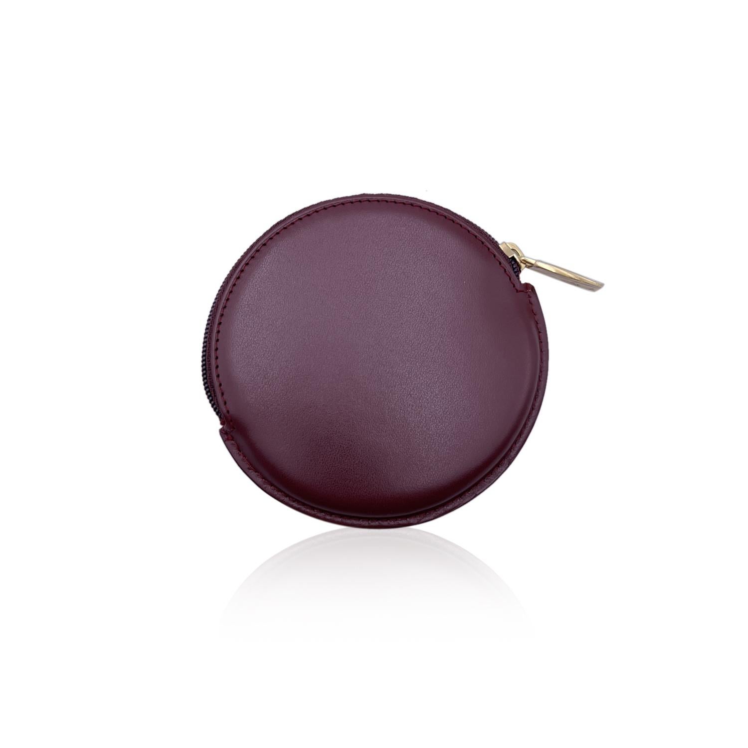 Burgundy leather Cartier round coin purse. Cartier logo embossed on the front. Upper zipper closure. Burgundy interior. 'Cartier Paris' embossed inside.






Details

MATERIAL: Leather

COLOR: Burgundy

MODEL: -

GENDER: Women

COUNTRY OF