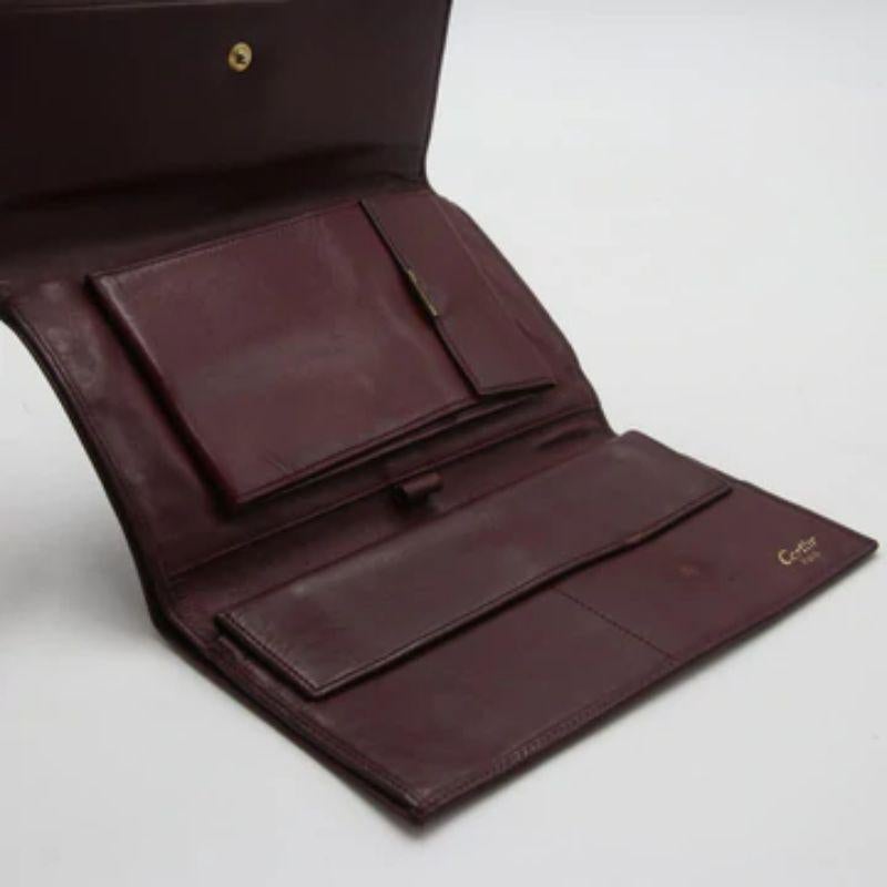 Black Cartier Burgundy Pebbled Leather Logo Tri-Fold Continental Wallet CR-W0930P-0405 For Sale