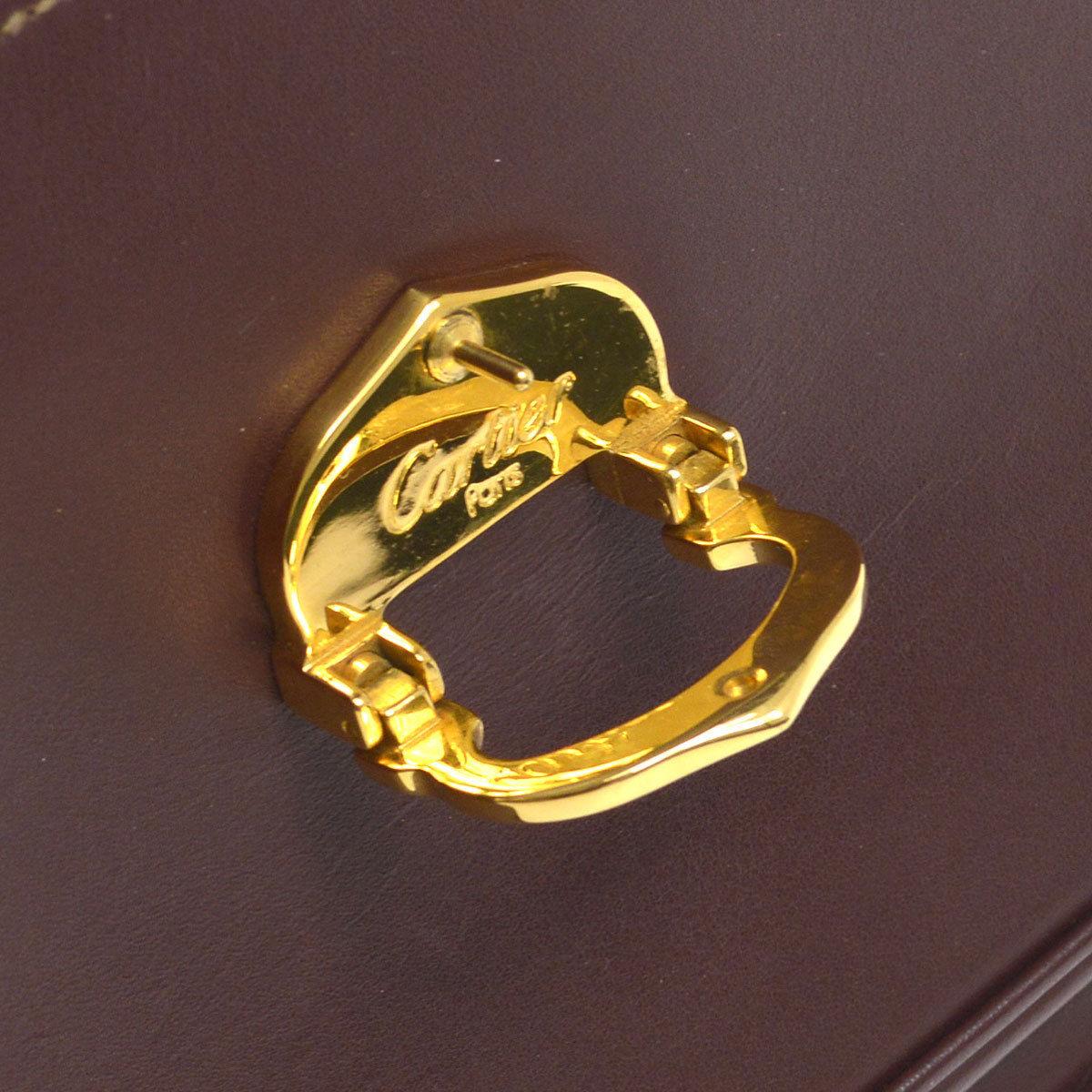 Cartier Burgundy Wine Leather Saddle Top Handle Evening Shoulder Flap Bag

Leather
Gold tone hardware
Flip lock closure 
Woven lining
Adjustable strap drop 9.5