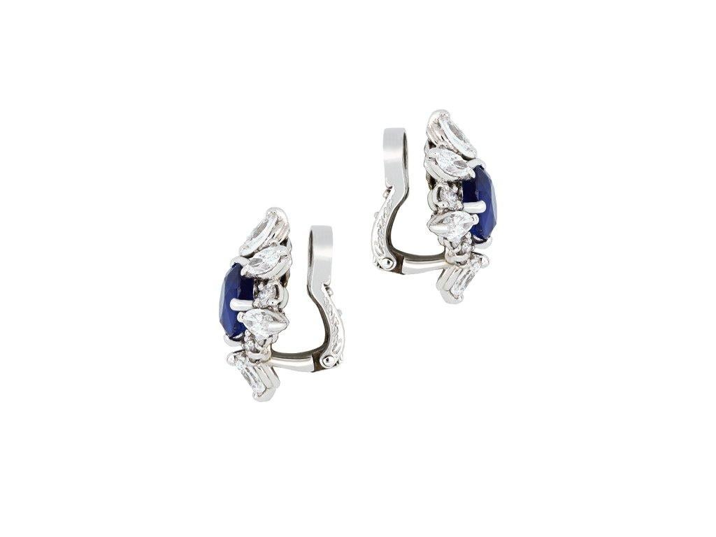 Cartier Paris Burmese Sapphire and diamond earrings. A matching pair, each centrally set with an oval old cut natural unenhanced Burmese sapphire in open back claw settings, one approximately 1.30 carats, the other 1.20 carats, each surrounded by