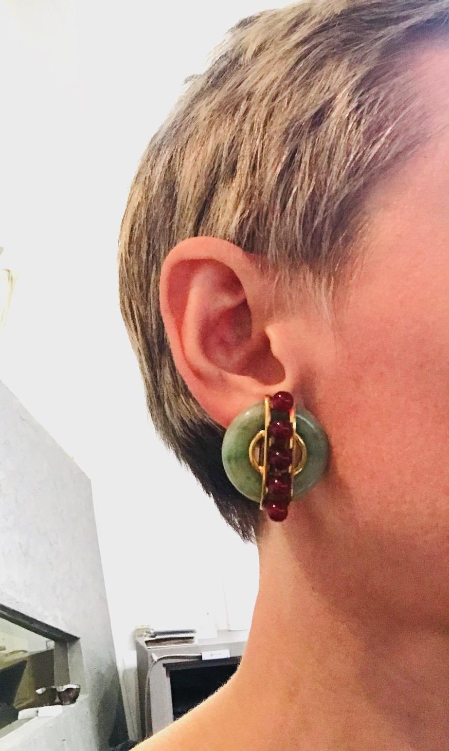 Vintage (c. 1970s) clip-on earrings by Aldo Cipullo for Cartier. Disks are made of jade. The carnelian balls are vertically framed in 18k yellow gold. Stamped with the A. Cipullo and Cartier makers marks, a year of production (1974) and a serial