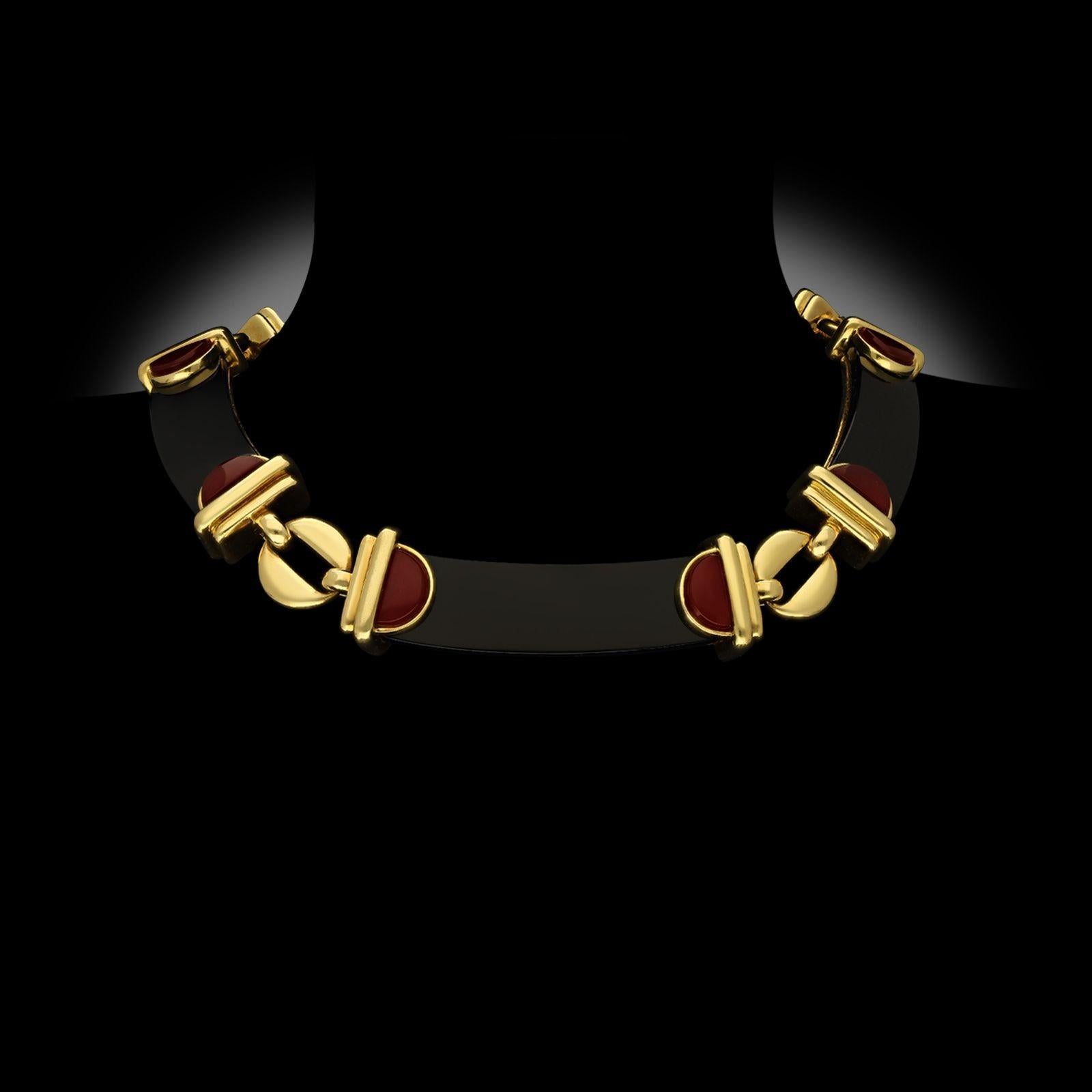 A vintage onyx, carnelian and 18ct yellow gold necklace by Cartier, designed by Aldo Cipullo, circa 1970. The necklace is designed as five uniform onyx plaques with oval carnelian plaques set either end, all set in 18ct yellow gold and connected