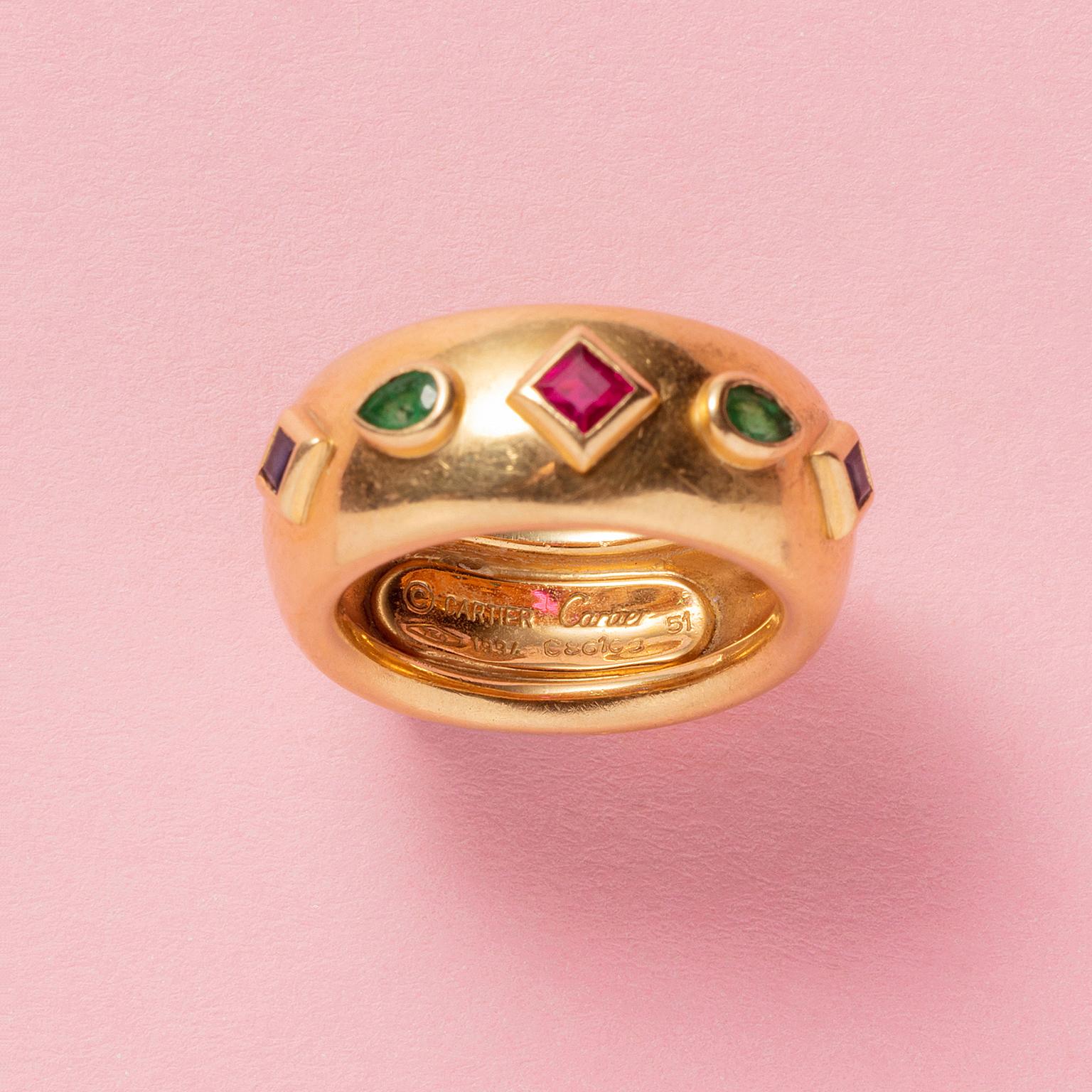 An 18 carat gold band ring set with a carré ruby in the middle with on each side two cut pear cut emeralds and two cut carré sapphires, signed, dated numbered: Cartier, 1994, model: Byzantine.

weight: 11.73 grams
ring size: 16.25 mm / 5.5