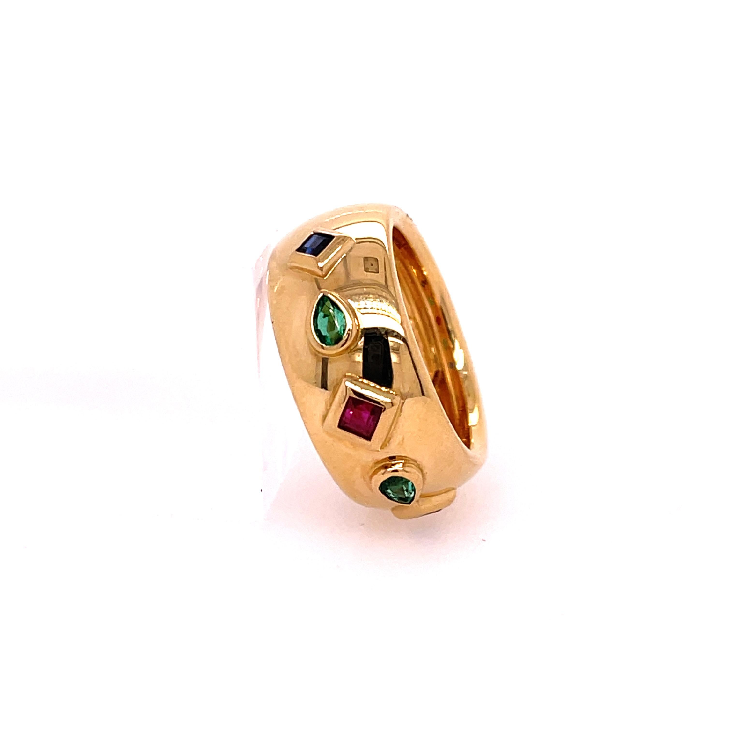 Cartier Byzantine Dome Band Yellow Gold & Gems. The band features two square cut sapphires, two pear shaped emeralds, and one square cut ruby. The width of the band is approximately 9.20mm. Ring size 5.5

10.6 grams