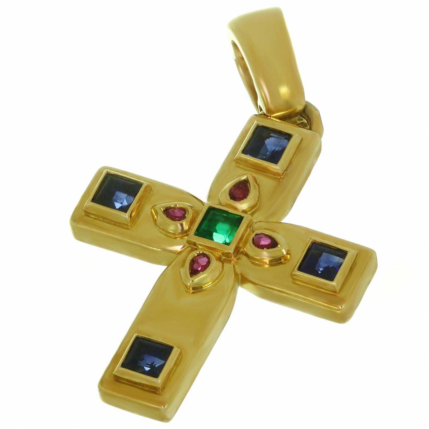 This iconic Cartier small cross pendant is crafted in 18k yellow gold and set with faceted rubies, sapphires, and emerald.  The Byzantine motif was designed by Louis Cartier during his trip to Russia in the early part of the 20th century, providing