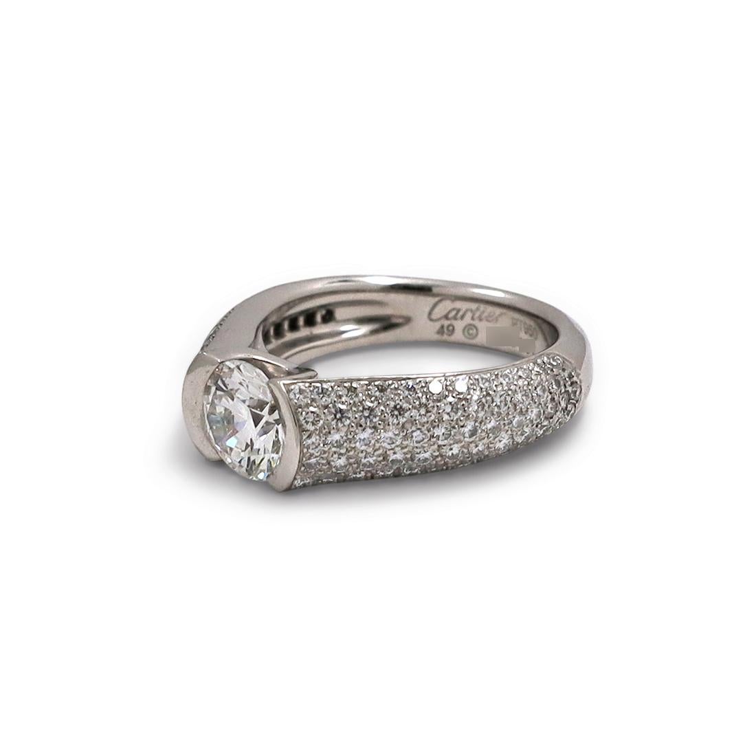 Authentic Cartier 'C de Cartier' engagement ring crafted in Platinum. Centering on a uniquely set GIA certified 1.02 carat round brilliant cut diamond (G color, VS2 clarity) and featuring an estimated 1.22 carats of pave set round diamonds. Size 49,