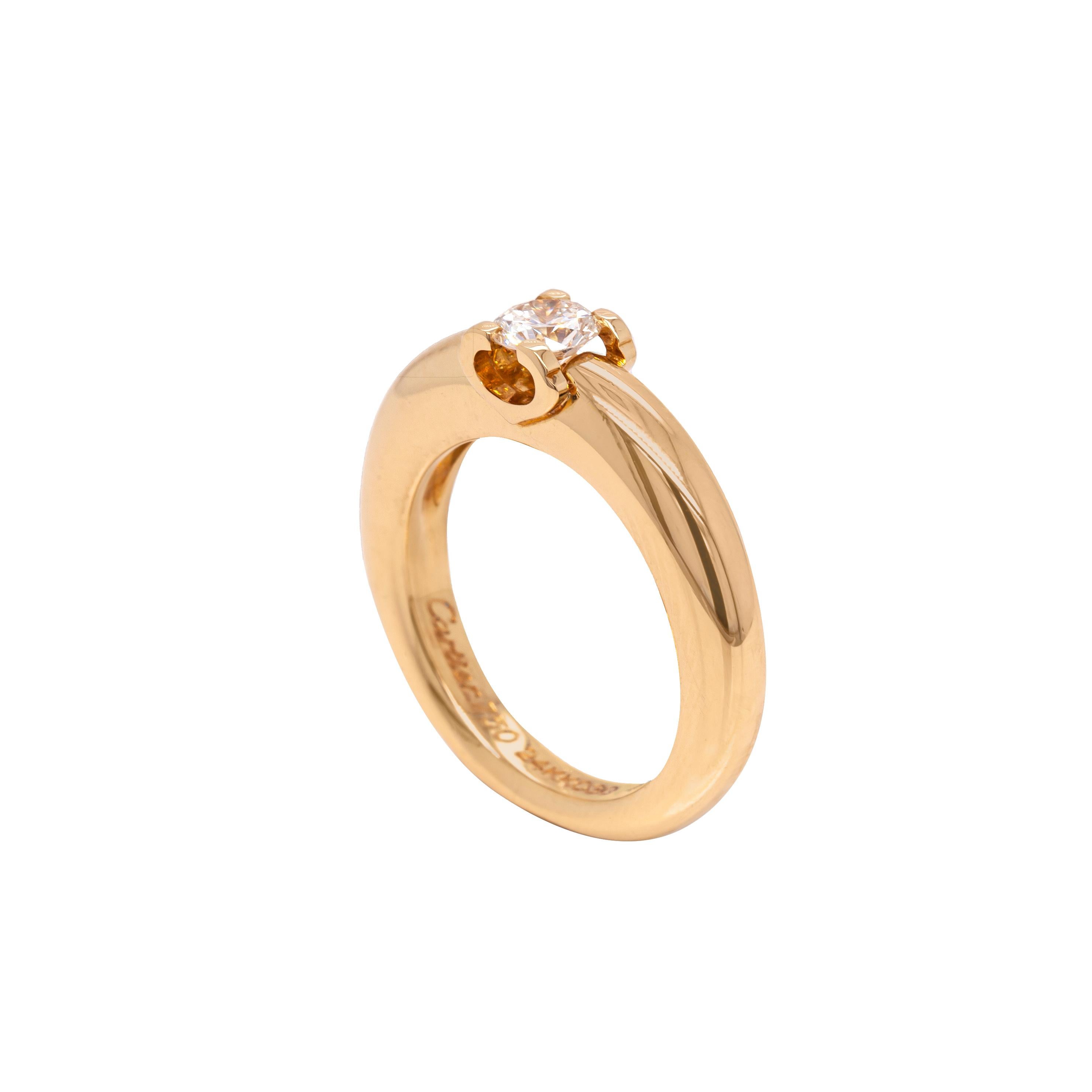 Stunning in its simplicity, this Cartier engagement ring from the 'C de Cartier' Collection is expertly crafted from 18 carat yellow gold. A beautiful round brilliant cut solitaire diamond weighing approximately 0.30ct, makes a statement in the