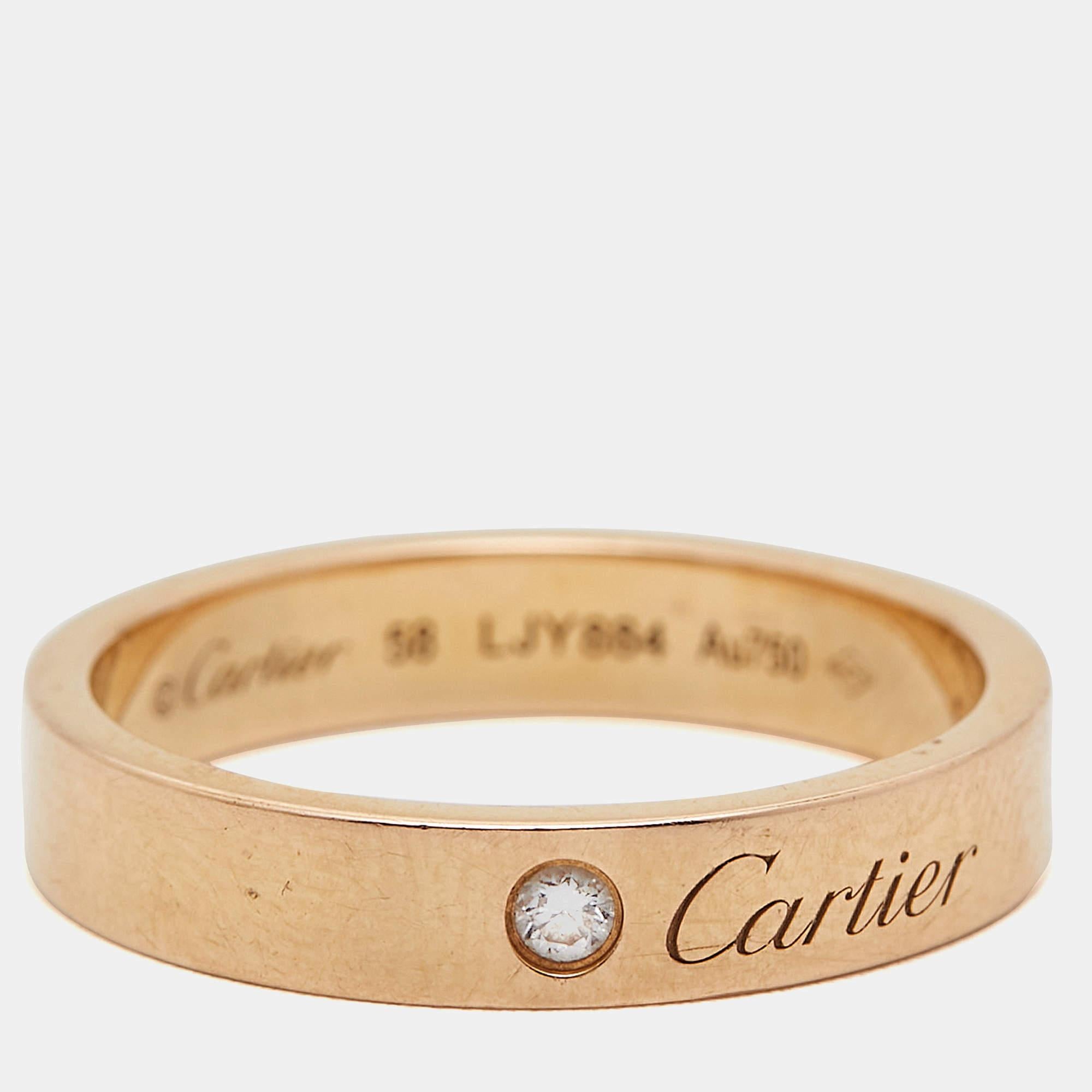 Crafted with exquisite artistry, the Cartier C De Cartier ring epitomizes timeless elegance. A radiant diamond delicately graces the band, set in 18k rose gold, symbolizing enduring love and commitment. This iconic piece seamlessly merges luxury and