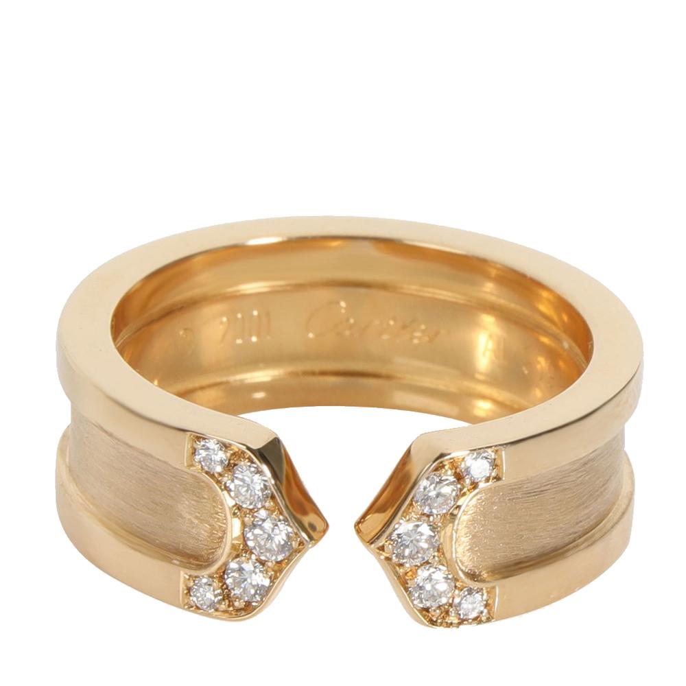 Quality matches precision in this stunning Cartier C de Cartier band ring. Crafted from 18K yellow gold and set with glittering diamonds, this ring is unique and classic. This elegant statement piece can be worn day and evening.

Includes: Original