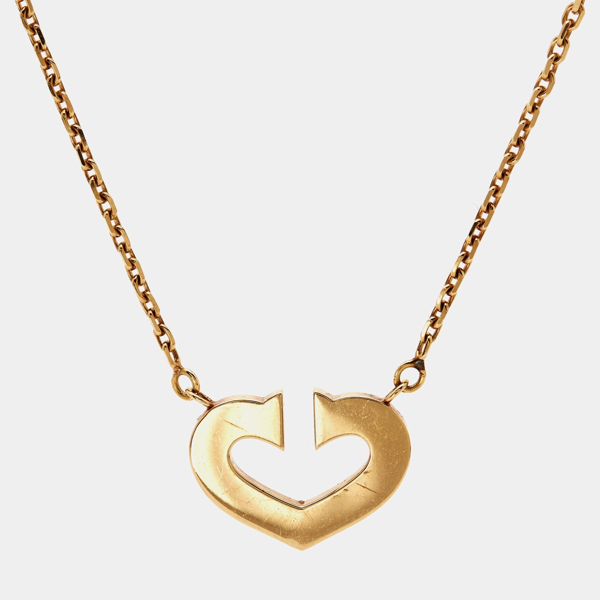 Cartier's C De Cartier necklace is an elegant piece of jewelry that can be sported with everyday ensembles for a subtly chic look. It has an open heart-shaped fixed pendant that exudes a polished finish. Rendered in 18k yellow gold, this minimally