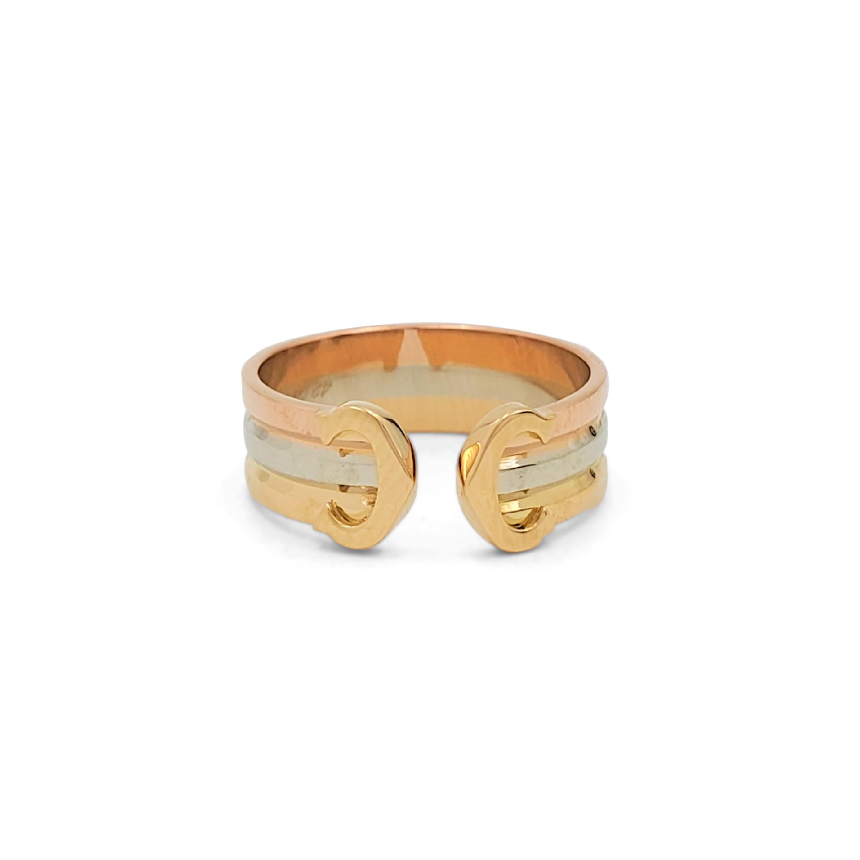 Authentic Cartier 'C De Cartier' ring crafted in 18 karat rose, white and yellow gold. The open shank ring is comprised of three bands of gold, each a new color. Cartier's trademark 'C' shape is featured at each end of the split facing inward. The