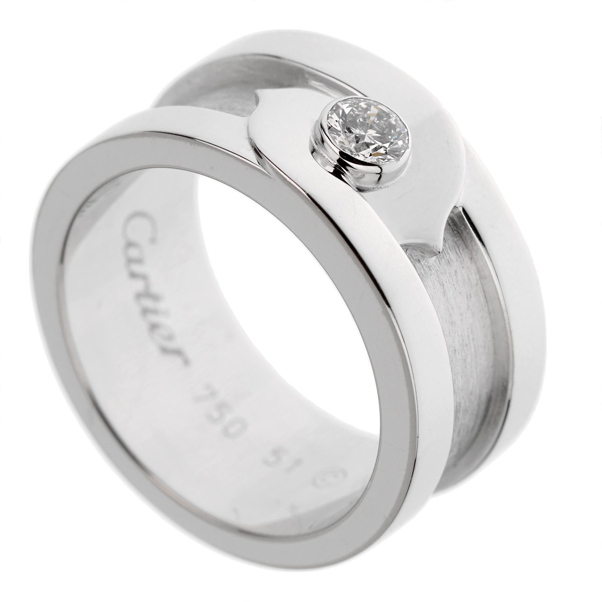 A chic Cartier diamond solitaire ring from the C de Cartier collection showcasing an original Cartier round brilliant cut diamond set in 18k white gold. The ring is circa 2005 and comes with the original Cartier certificate. Size 51 eu / 5 us