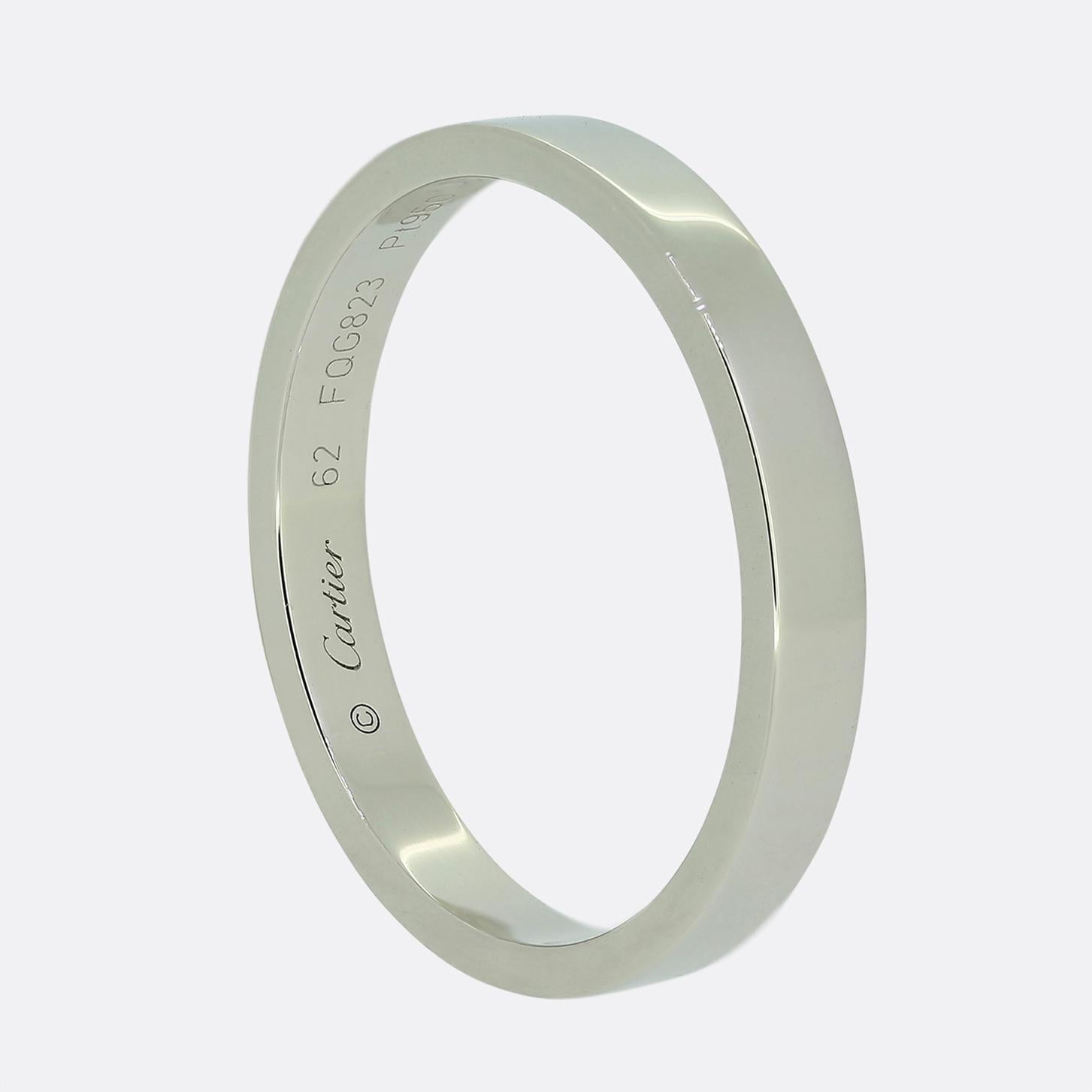 Here we have a sleek platinum band ring from the world renowned jewellery house of Cartier. The ring features a minimalist design with a smooth, polished finish. The Cartier name is elegantly engraved at the centre of the face whilst the band is