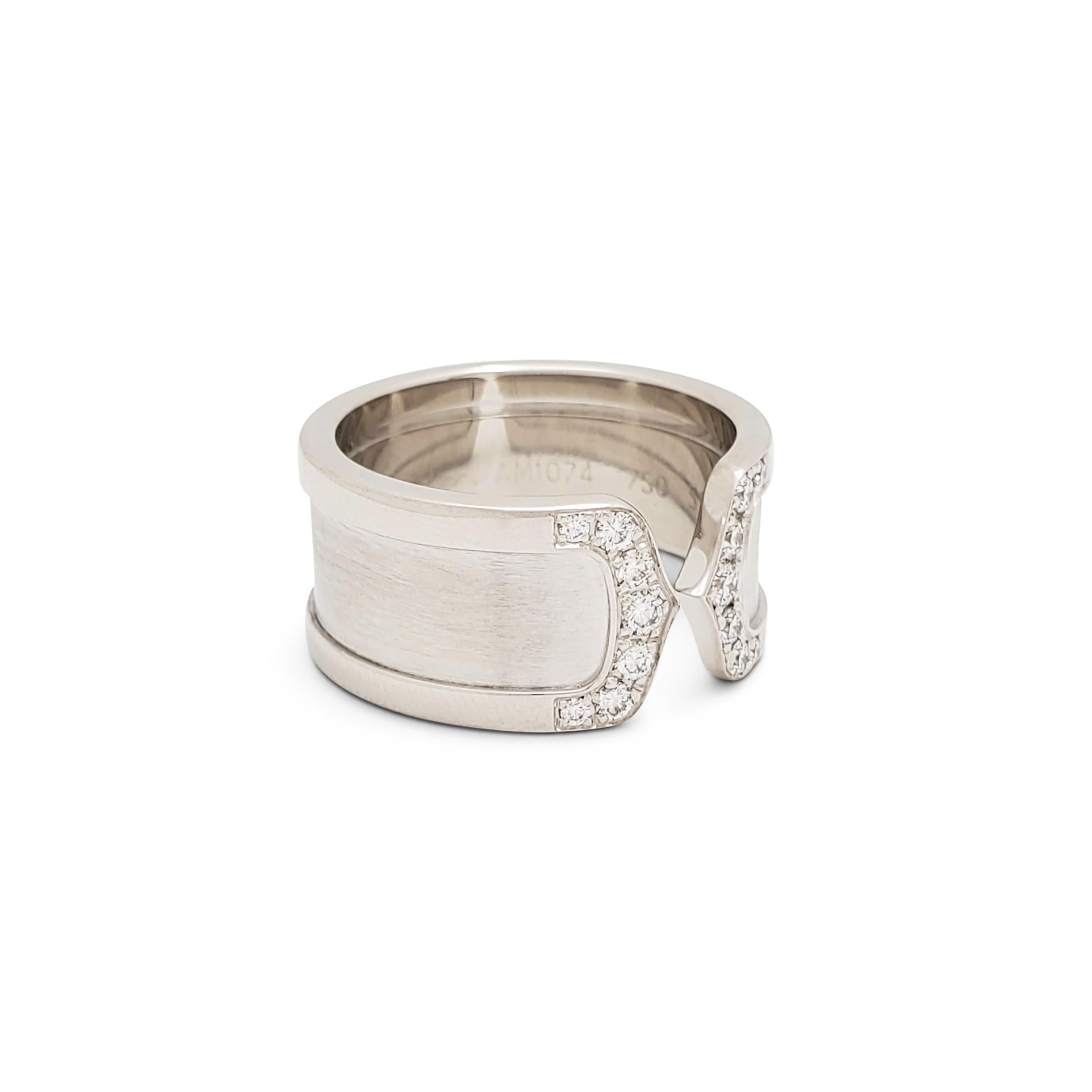 Authentic Cartier 'C De Cartier' ring crafted in 18 karat white gold. The split ring is comprised of a band of brushed white gold framed by high polished white gold. The C motif at each end is set with round brilliant cut diamonds of an estimated