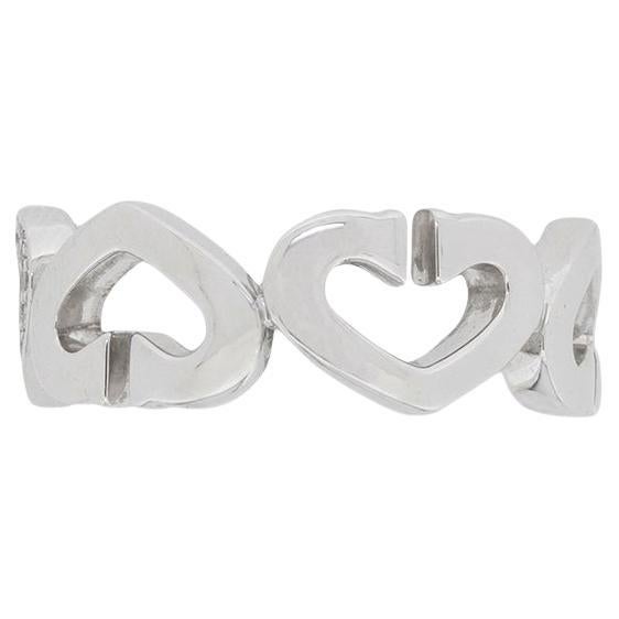 A ring from the C Heart collection presented by Cartier. The collection is about simplicity and using the Heart symbol to show elegance. This ring consists of 6 heart shapes adjacent to one another. They also have a slight curve into a ‘C’ shape at