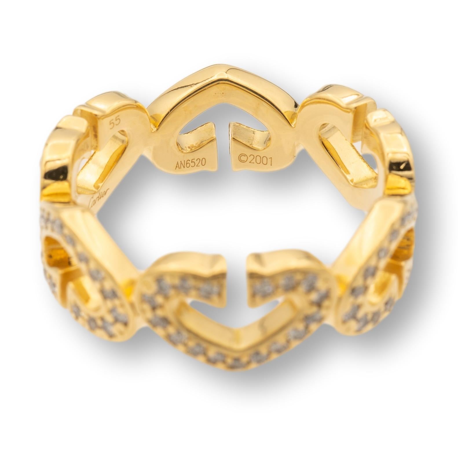 Cartier ring from the C de Cartier collection finely crafted in 18 karat yellow gold with pave diamonds set in six heart motifs going all the way around. Ring is fully hallmarked with Cartier serial numbers and metal content.

RING