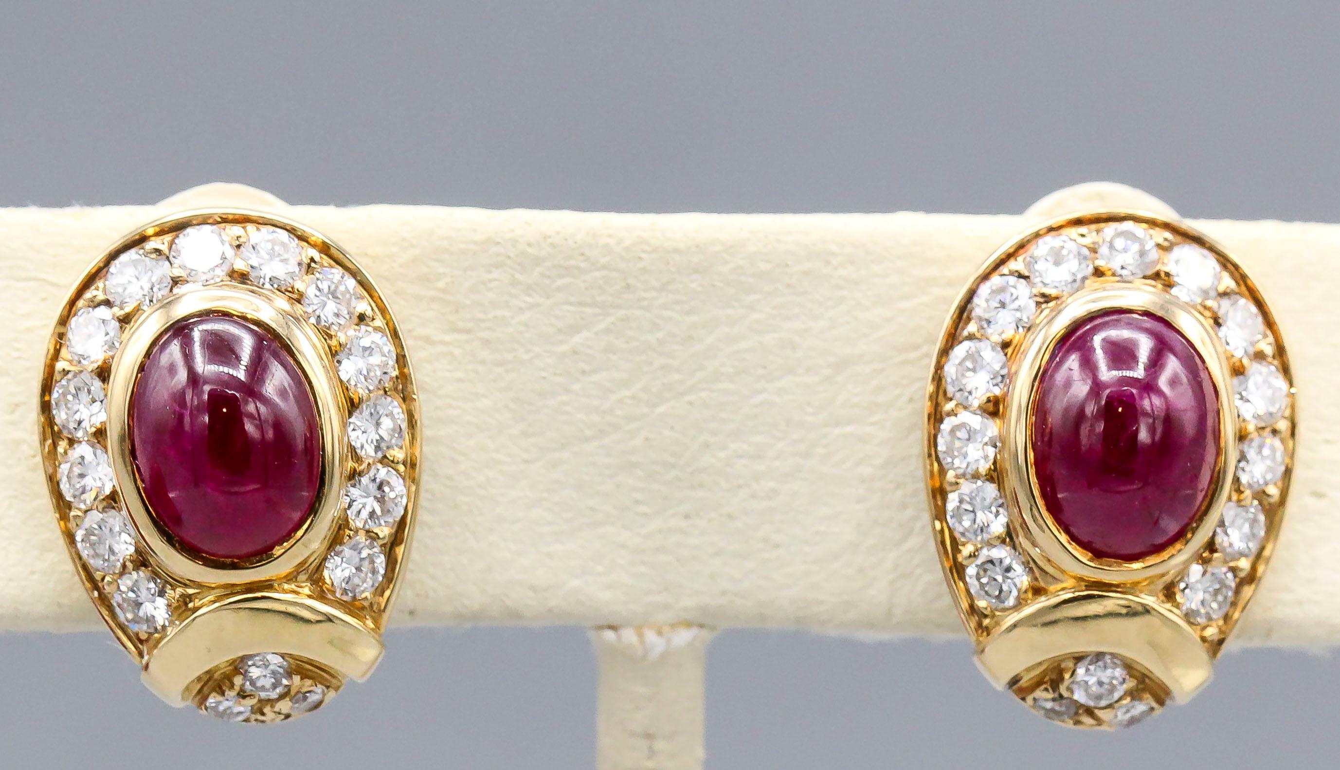 Elegant cabochon ruby, diamond and 18K yellow gold earrings by Cartier, made in Paris. They feature rich red oval cabochon rubies in the center, surrounded by very high grade round cut diamonds. Beautifully made and great for day or evening