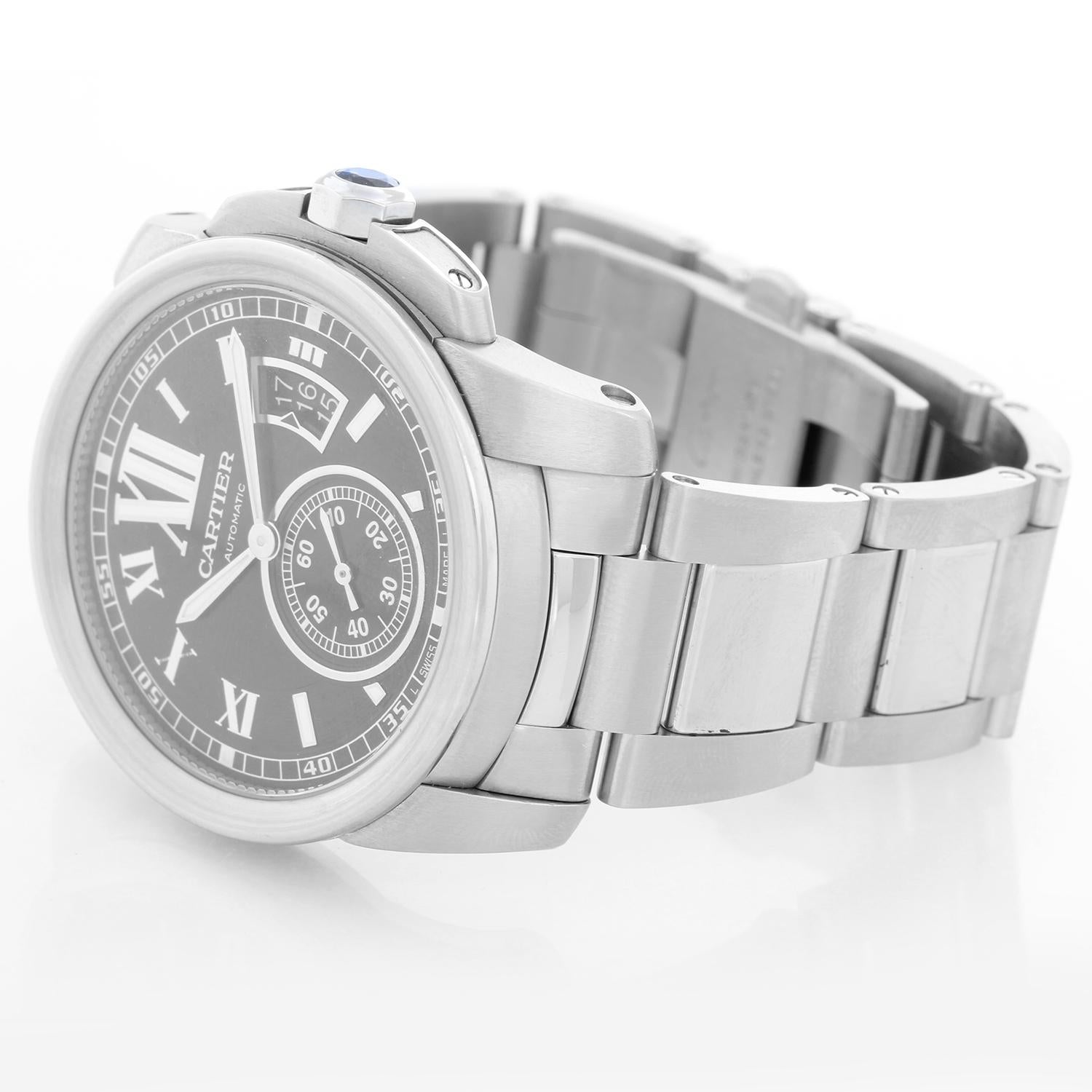 Cartier Calibre de Cartier Men's Stainless Steel Watch W7100037 3389 - Automatic winding. Stainless steel case (42mm diameter). Black dial with white Roman numerals and stick markers; date at 3 o'clock, subseconds at 6 o'clock. Stainless Steel