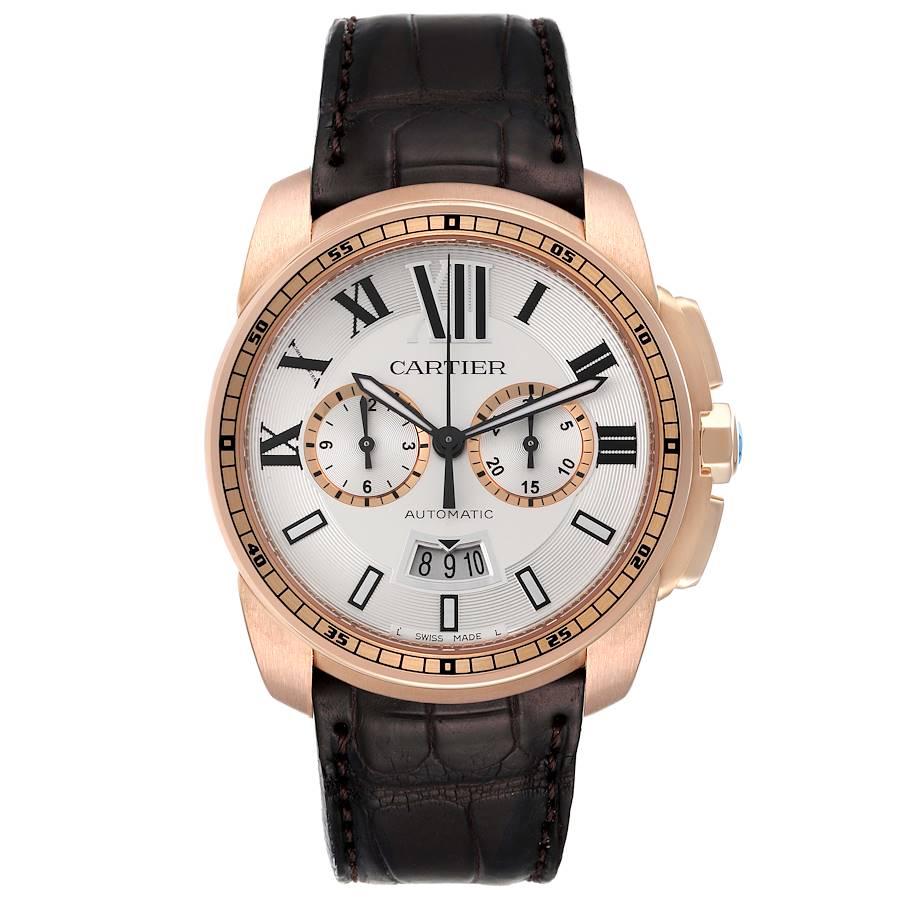 Cartier Calibre Silver Dial Rose Gold Chronograph Mens Watch W7100044. Automatic self-winding chronograph movement. 18K rose gold round case 42 mm in diameter. Case thickness: 12.6 mm. 18K rose gold crown set with faceted blue sapphire. 18K rose