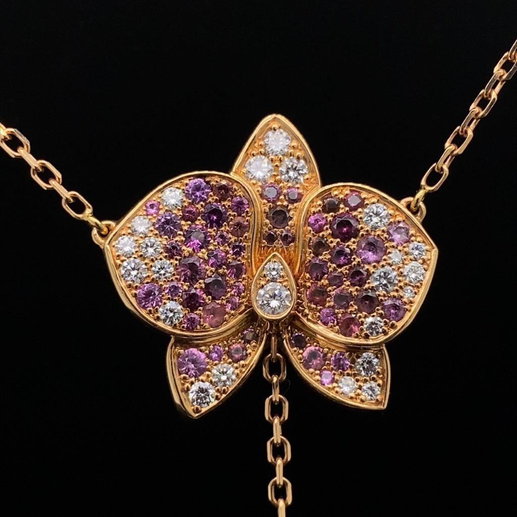Cartier Caresse d'orchidée pink sapphire, diamond and rose quartz orchid necklet.

A light and beautiful flower necklet, the pendant modelled as an orchid, the petals pave set with round brilliant cut diamonds and pink sapphires completed by an