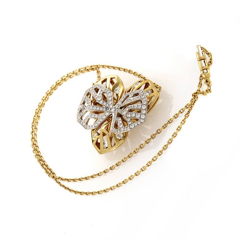 A rare find from Cartier's Caresse d'orchidées collection, this pendant necklace is sure to please! The necklace is made of 18K yellow gold as well as its floral-inspired pendant. Lastly, the pendant is accented with an openwork 18K white gold
