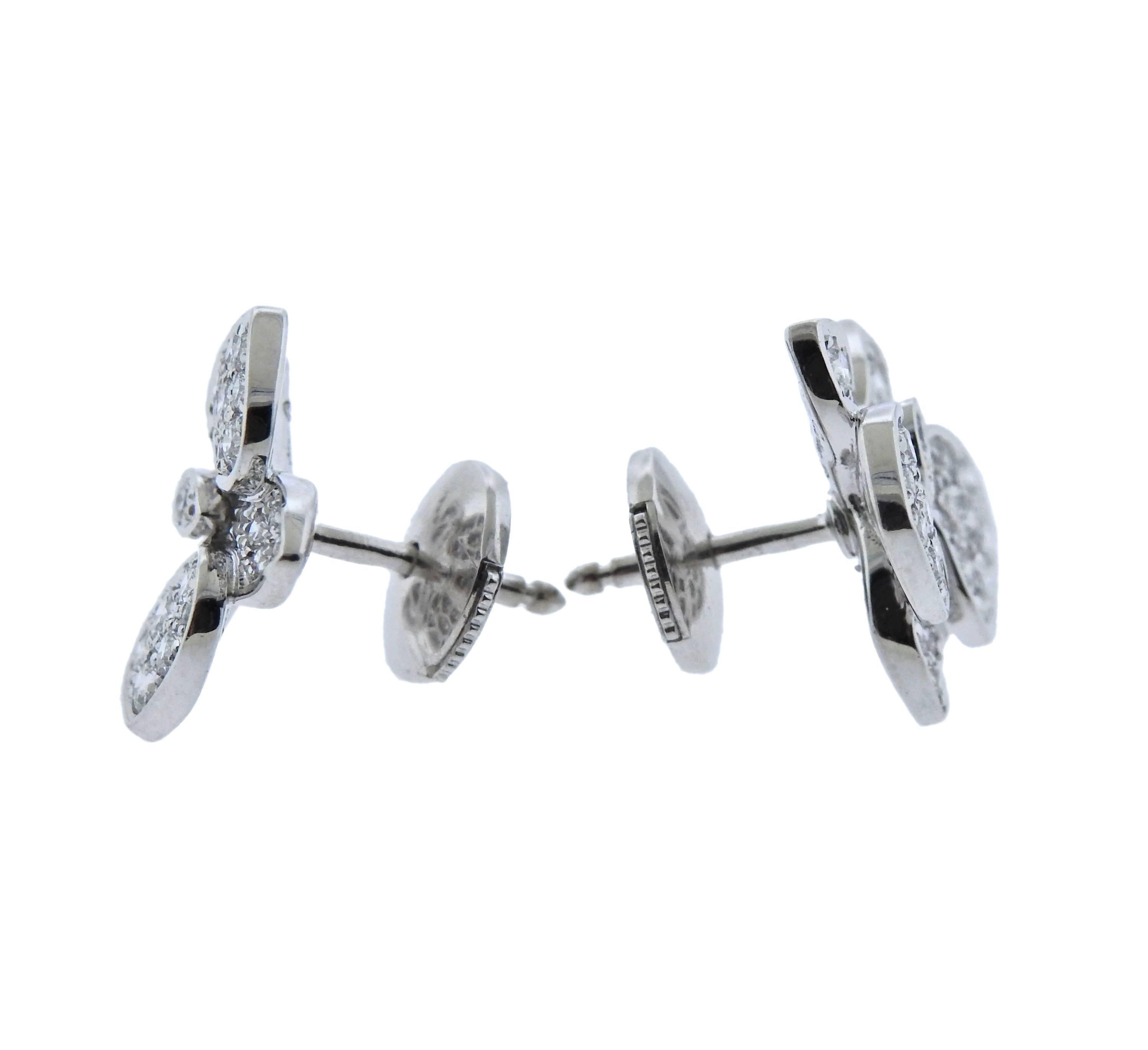 Pair of 18k white gold and diamond earrings, crafted by Cartier for Caresse d'Orchidees collection. Retail $11100. Come with box and COA.  Earrings are 14mm x 14mm, weigh 4.9 grams. Marked: Cartier, 750, OO1878.