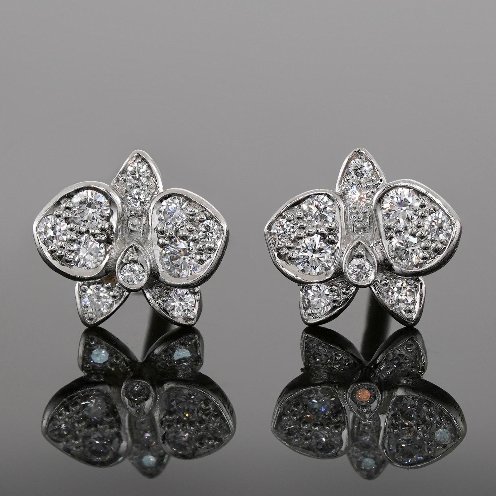 These exquisite stud earrings from Cartier's Caresse D'orchidees collection feature a delicate flower design crafted in 18k white gold and set with round brilliant D-E-F VVS1-VVS2 diamonds. This is the mini model of the earrings. Made in France