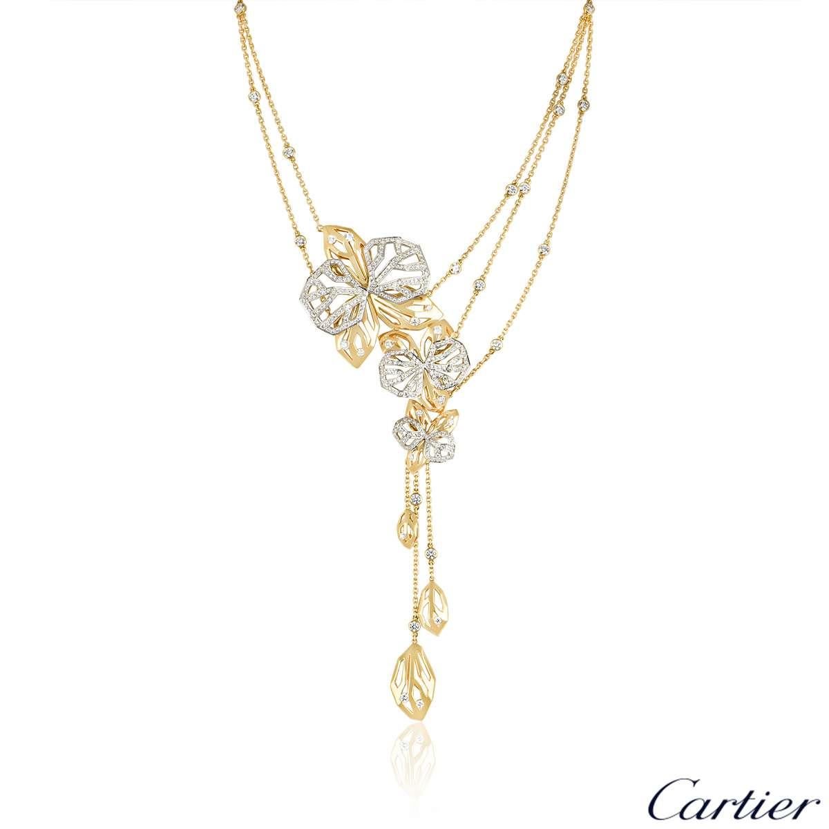 A rare 18k yellow and white gold necklace and ring suite from the Caresse d'Orchidees collection by Cartier. The ring and necklace are of openwork design and feature round brilliant cut diamonds. The ring has a total of approximately 1.60ct and the