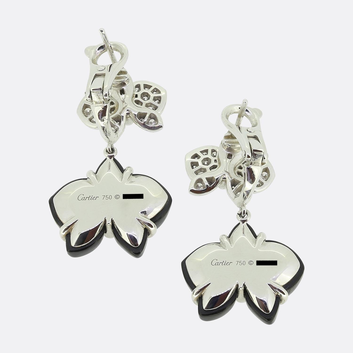 Here we have a stunning pair of drop earrings from the world renowned luxury jewellery house of Cartier. These delicate earrings have been crafted from 18ct white gold and feature a duo of orchids. The first has been pave set with a shimmering array