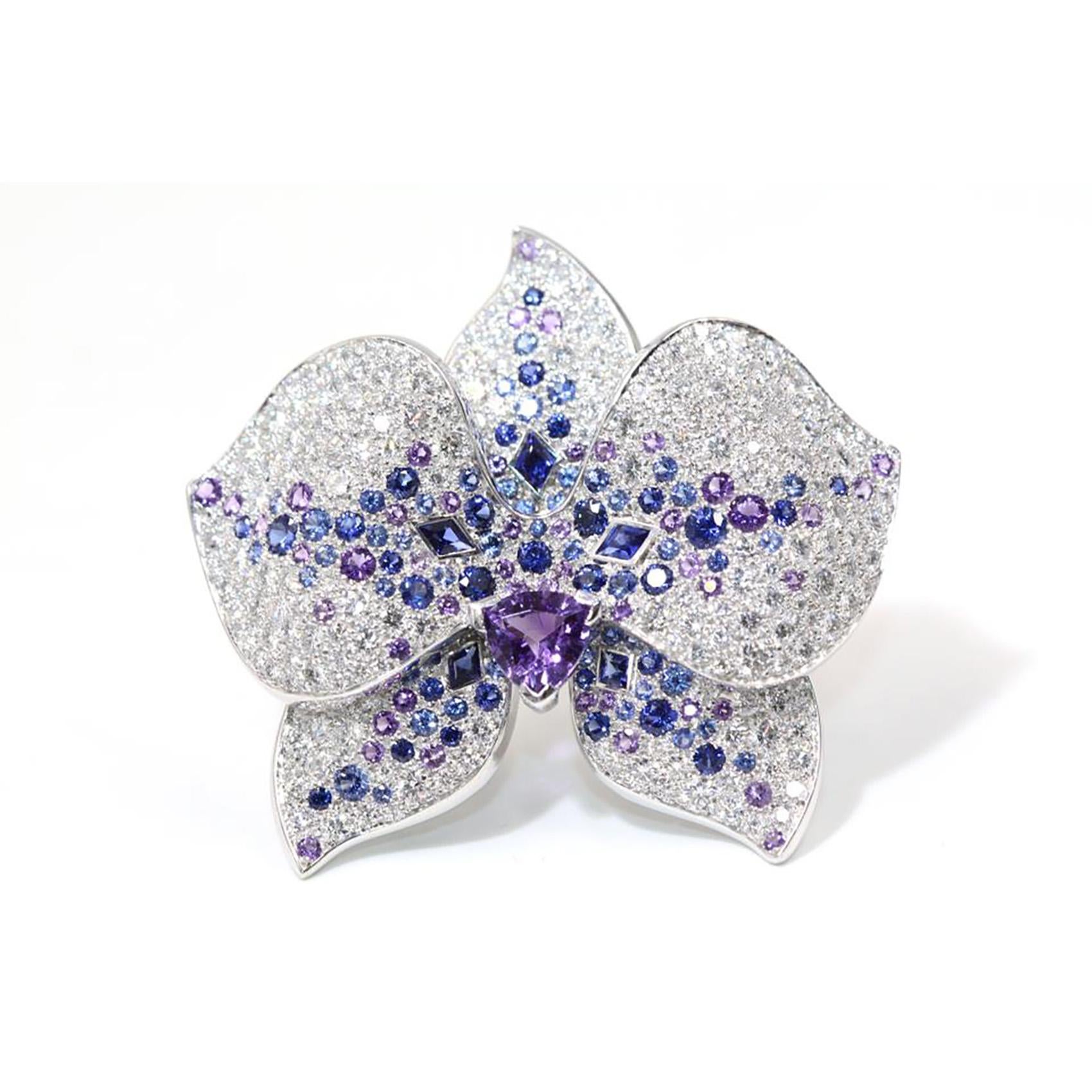 Designer: Cartier
Collection: Caresse d'Orchidees
Metal: White Gold
Metal Purity: 18k
Ring Size: 7 (US)
Stones: Round Brilliant Cut Diamonds, Amethyst, Sapphire

A popular flower at Cartier, the orchid demonstrates a delicate, feminine appeal. The