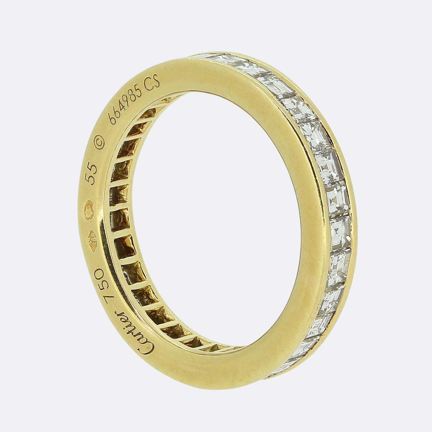 Here we have a truly stunning eternity ring from the world renowned luxury jewellery house of Cartier. This piece showcases 31 carré cut diamonds which have been expertly channel set from edge to edge amidst a rich 18ct yellow gold bordering above