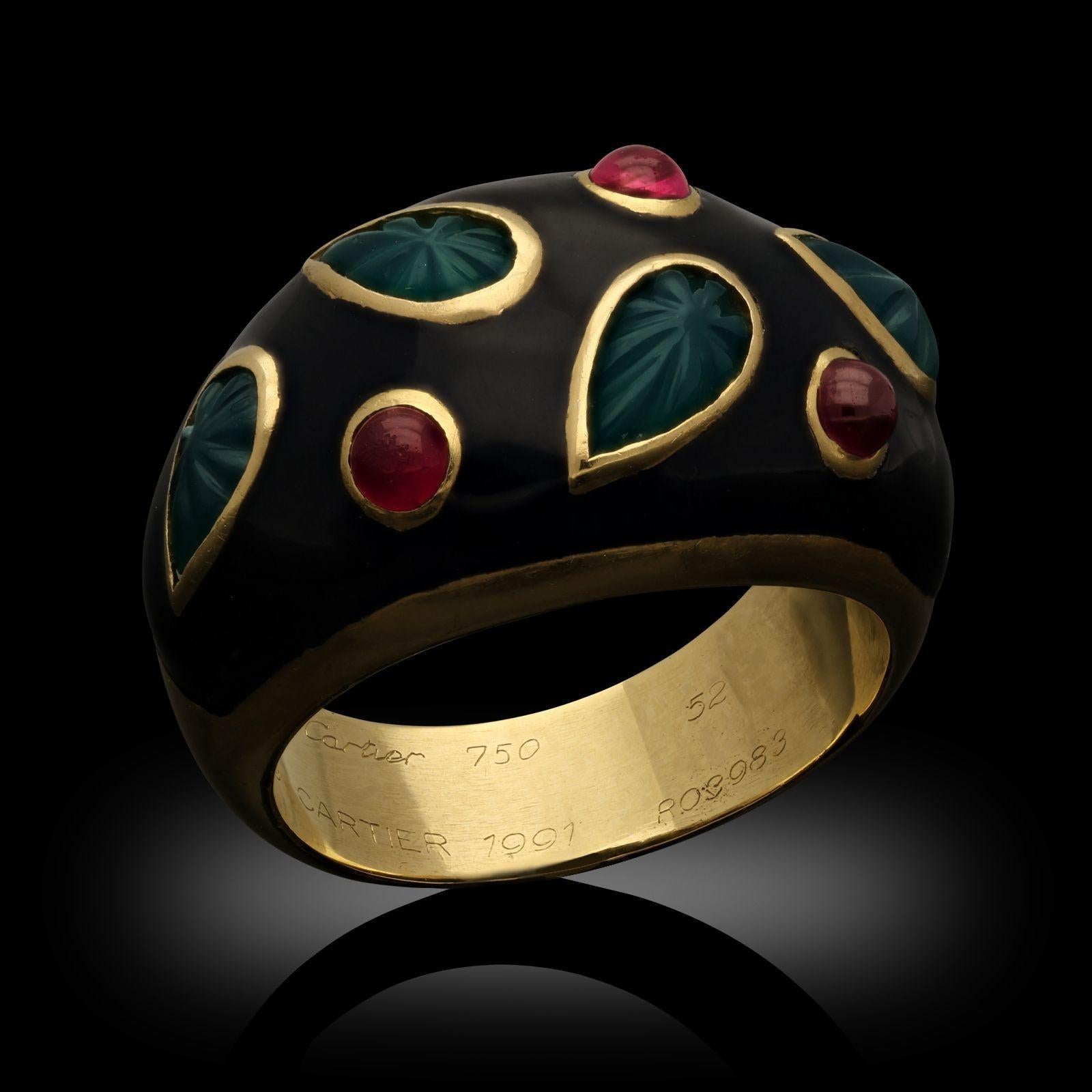 A vintage multi gem and black lacquer ring by Cartier. The ring is designed in a bombe shape set with carved chrysoprase leaves & round cabochon rubies all set in 18ct yellow gold with a black lacquer finish to the top, the gold band tapers to the