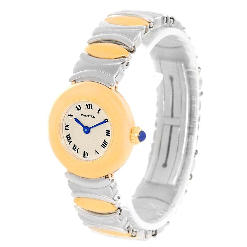 Cartier Casque Ladies Stainless Steel 18k Yellow Gold Watch. Quartz movement. 18k yellow gold round case 24.0 mm in diameter. Circular grained crown set with the blue sapphire cabochon. Mineral glass crystal. Silvered grained dial. Painted black