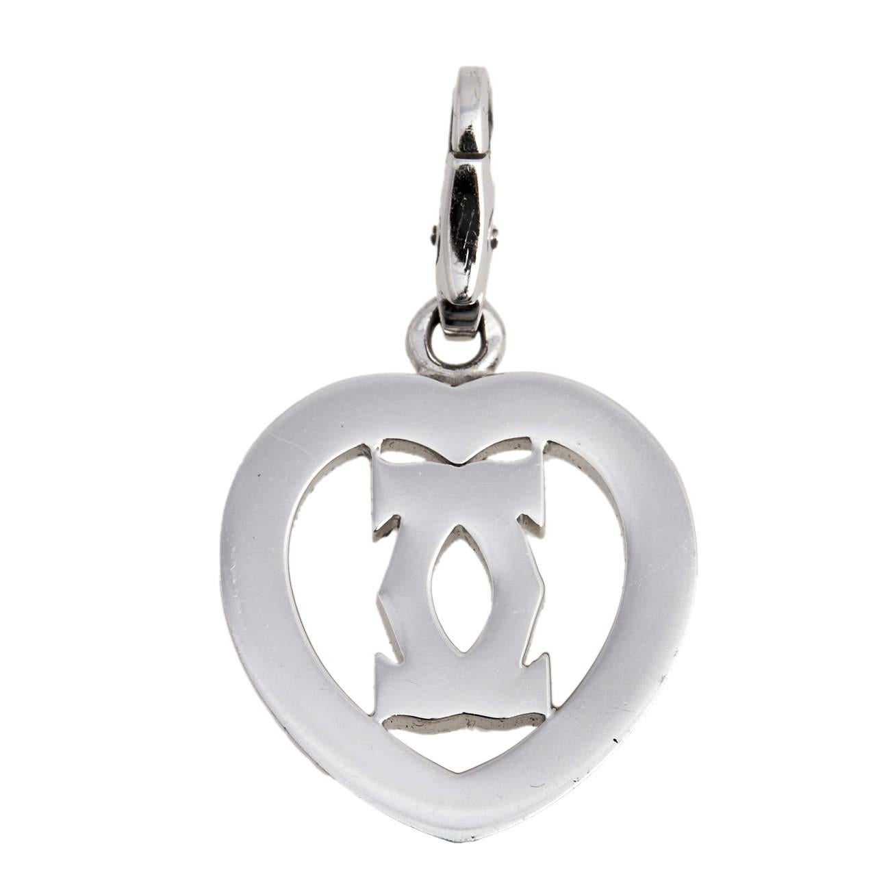 Give your evening ensemble a luxurious upgrade with this pendant from the house of Cartier. Designed from 18k white gold, this pendant forms a beautiful diamond-embellished CC design stationed inside an open heart. Give yourself a sleek look by